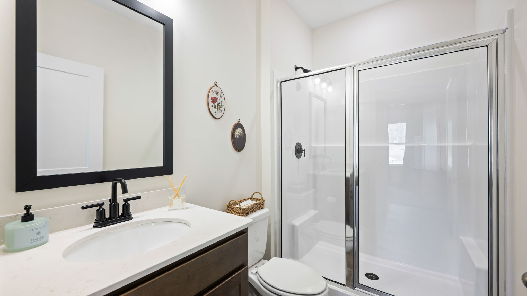 Downstairs bathroom with single bowl sink and walk in shower