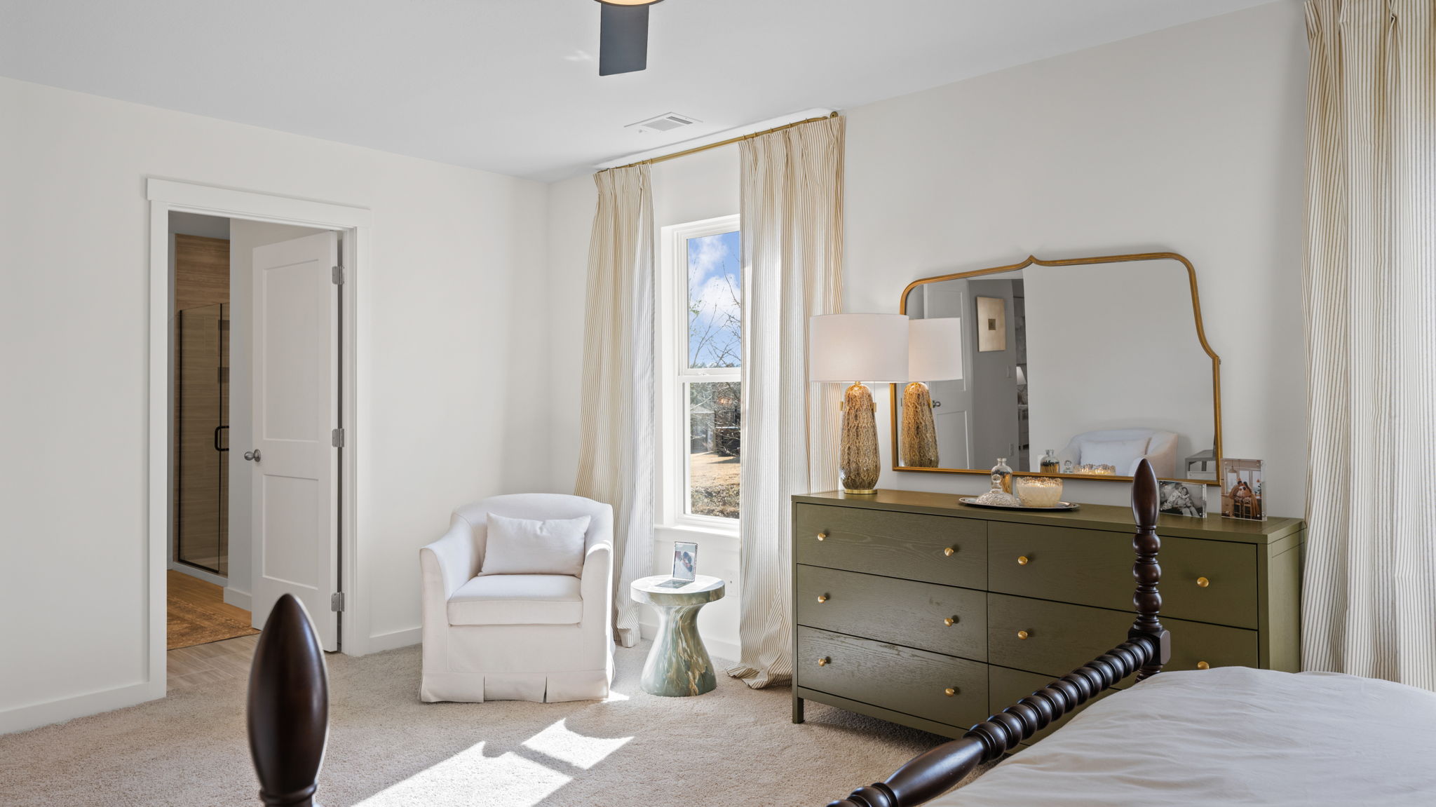 primary bedroom with two single windows and en suite