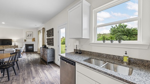 kitchen with informal dining to the left and back patio door to the right