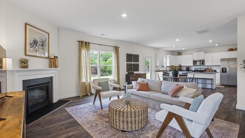 open concept living room facing informal dining and kitchen