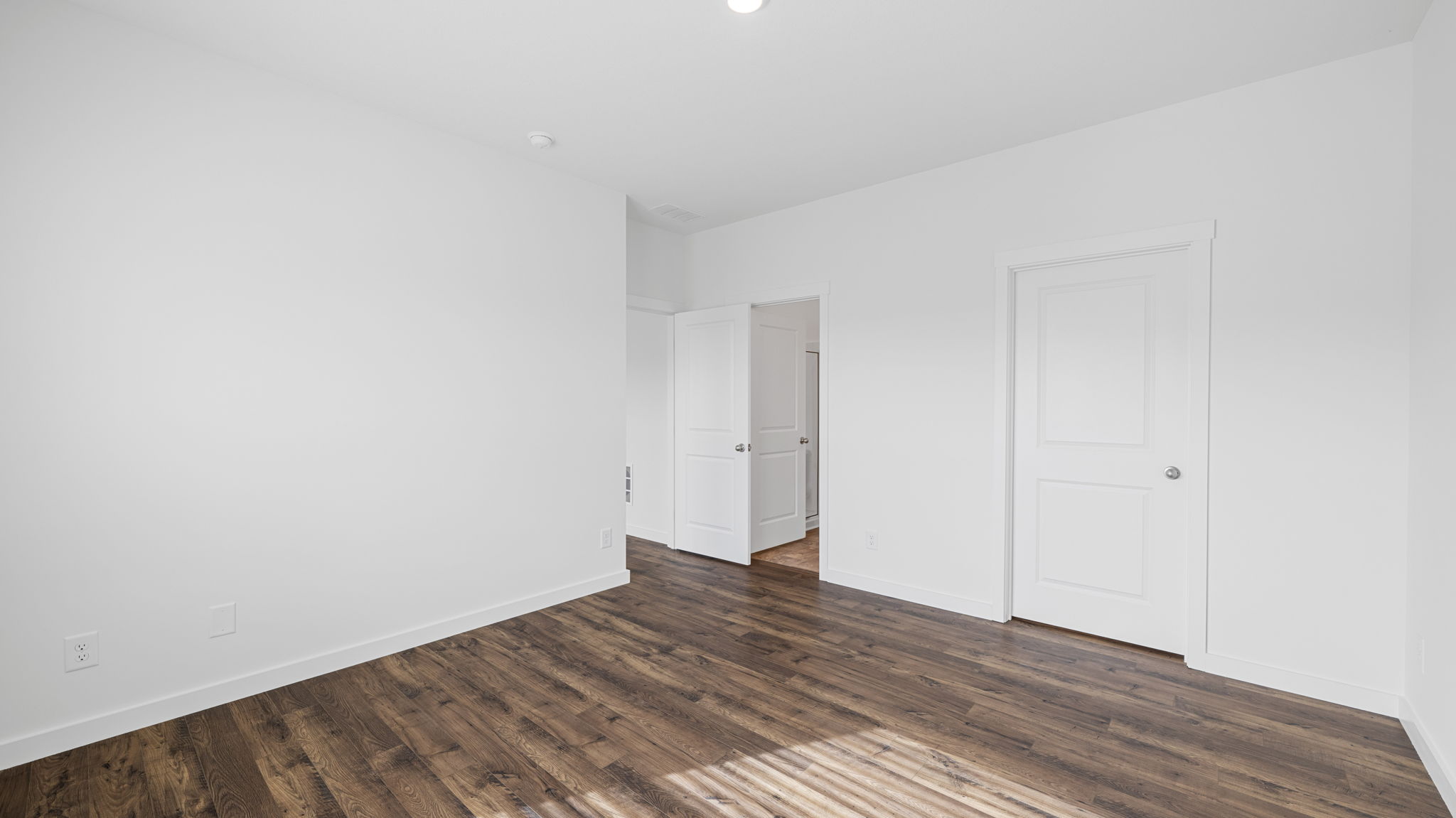 primary bedroom with double window and en suite