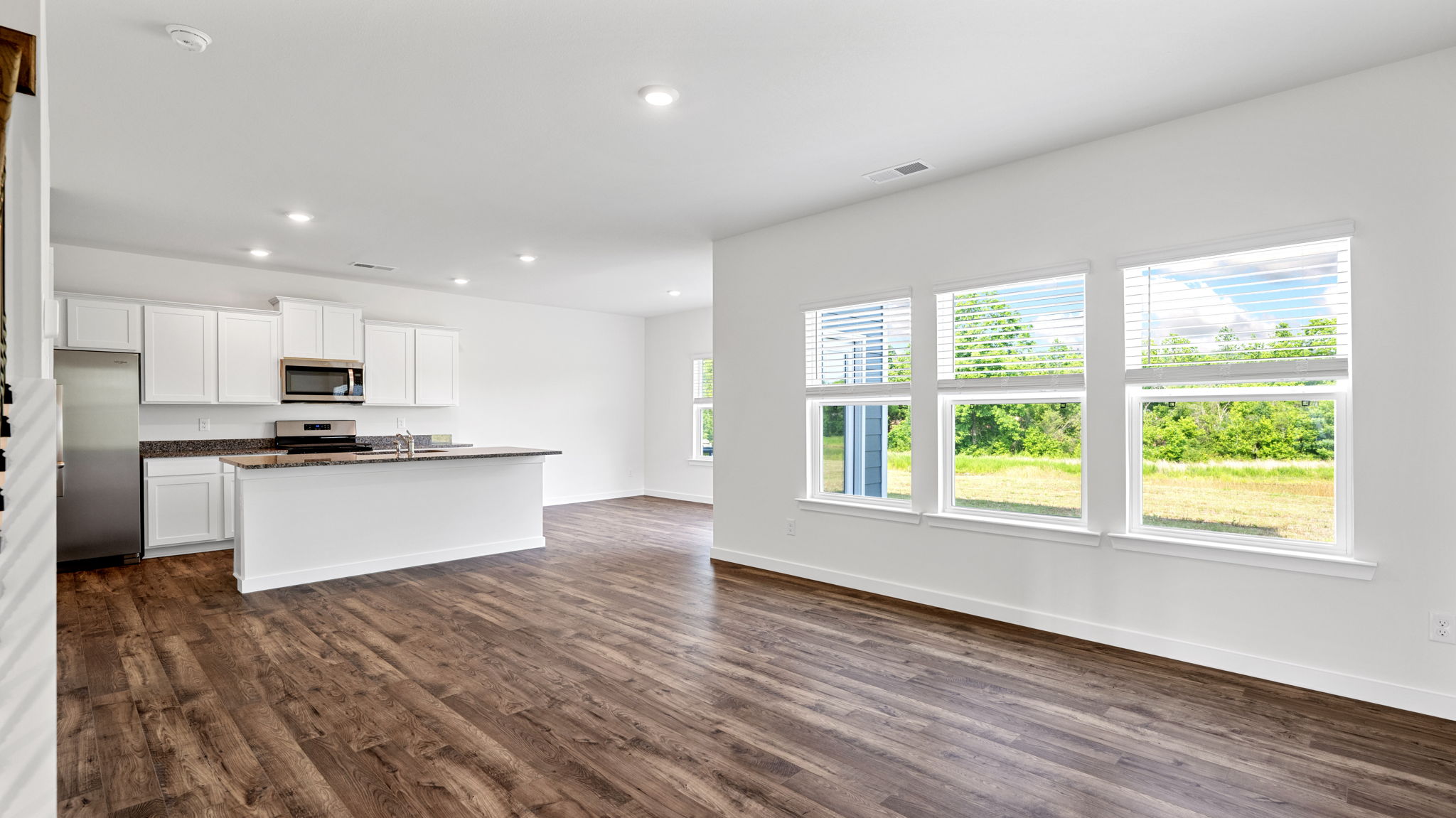 open concept living room with triple window