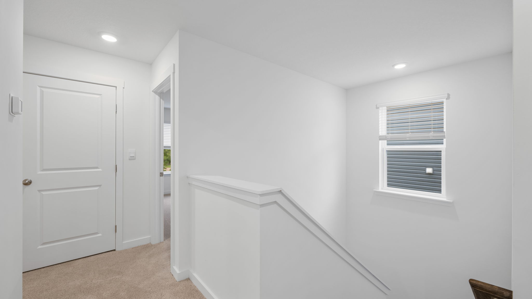 upstairs hallway with single window in stairwell
