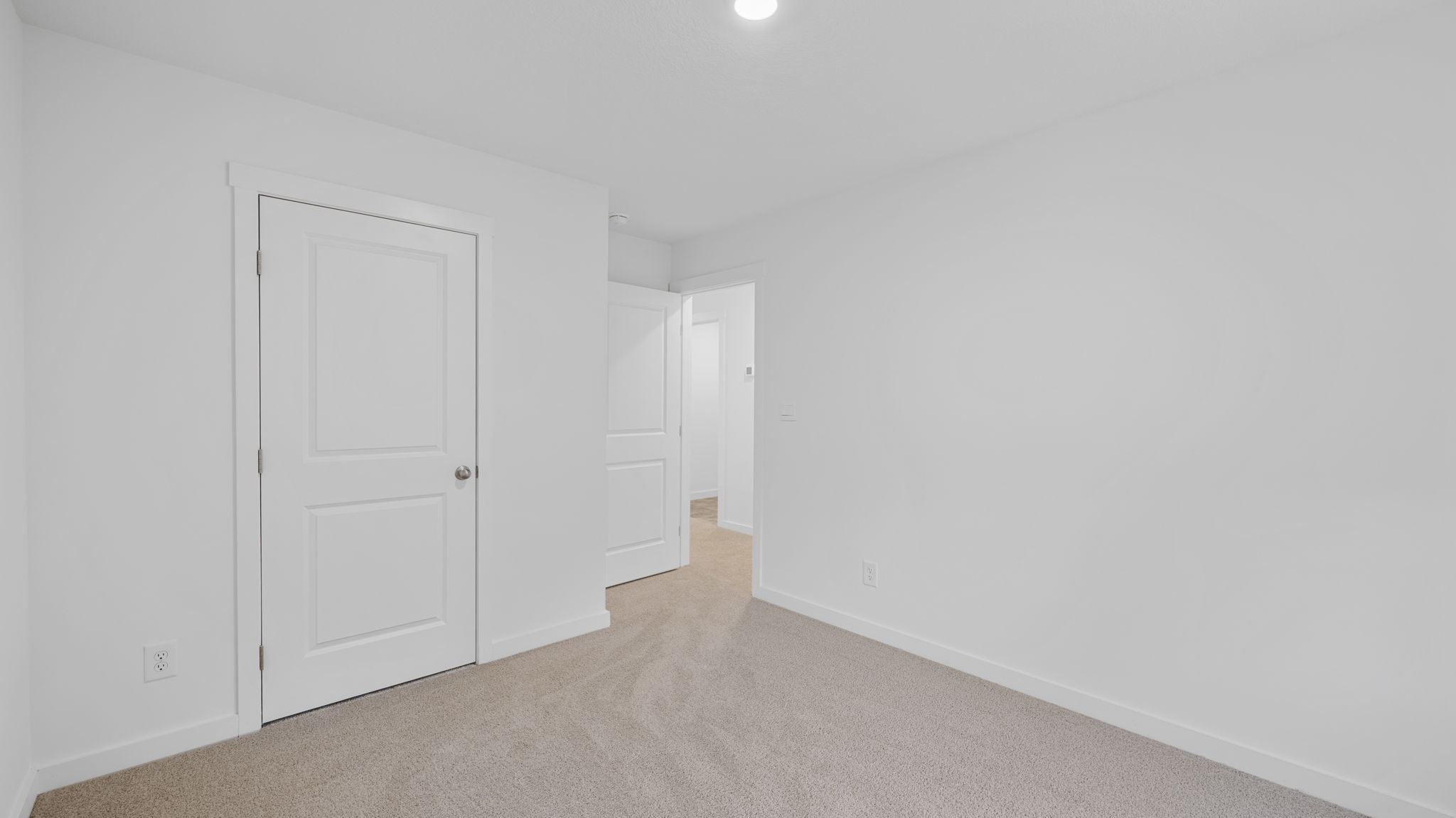 bedroom with single window and walk-in closet