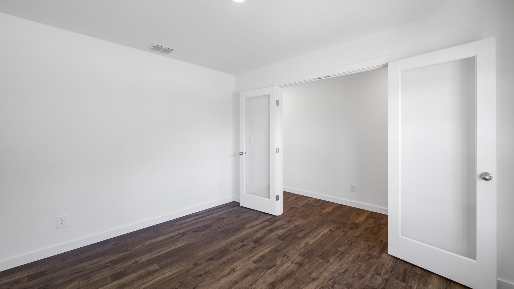 front room off entry with doubke glass doors