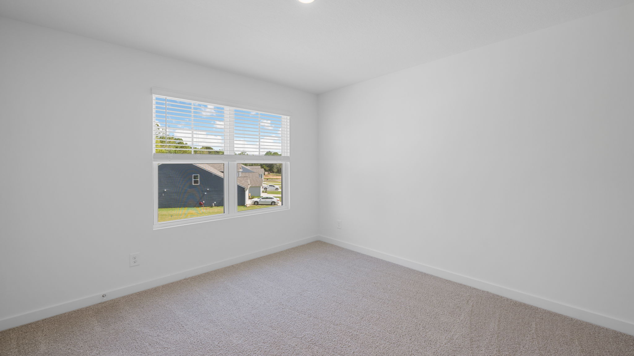 guest room on second level with window and carpet