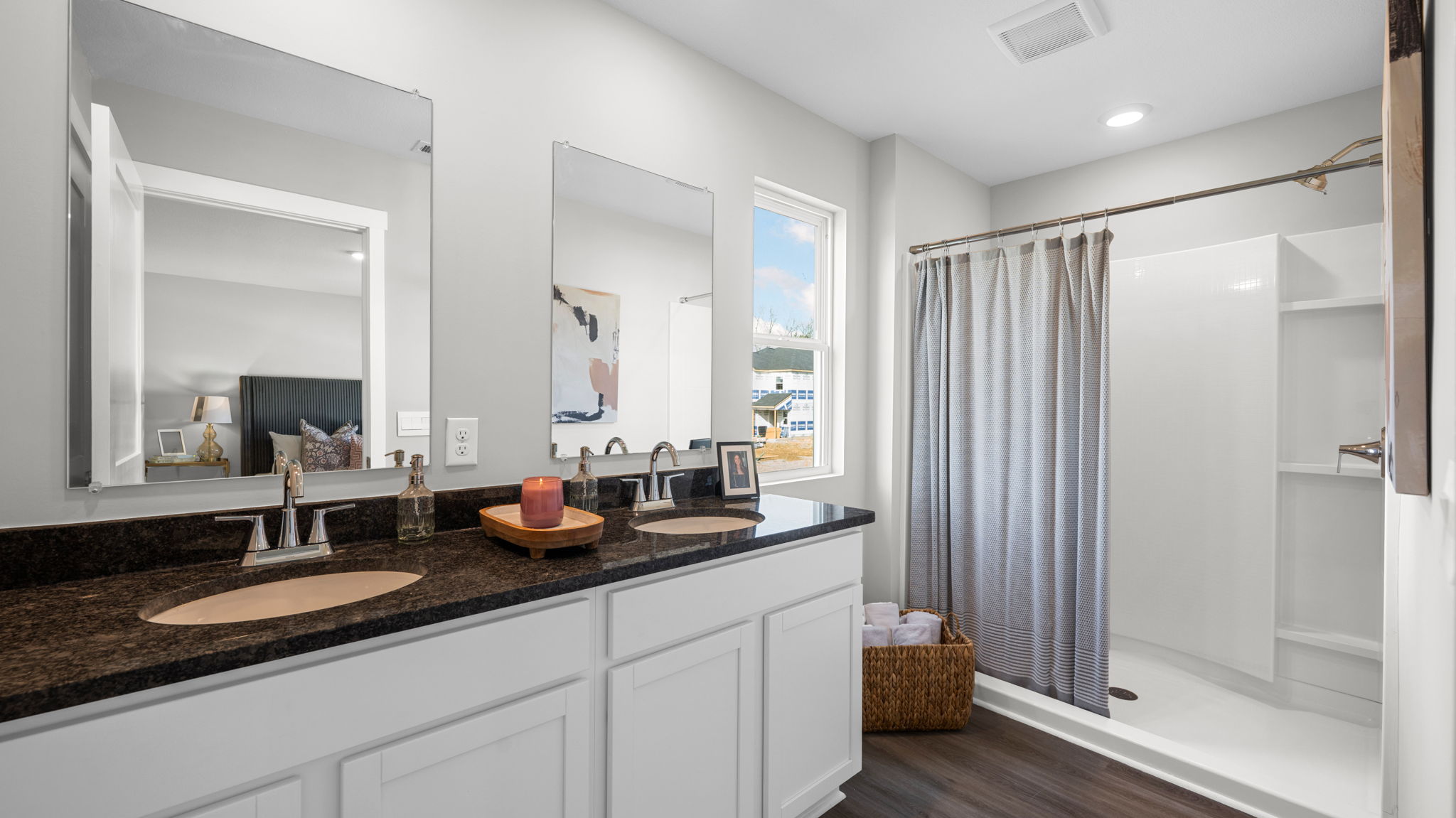 primary bathroom with double vanity and walk-in shower
