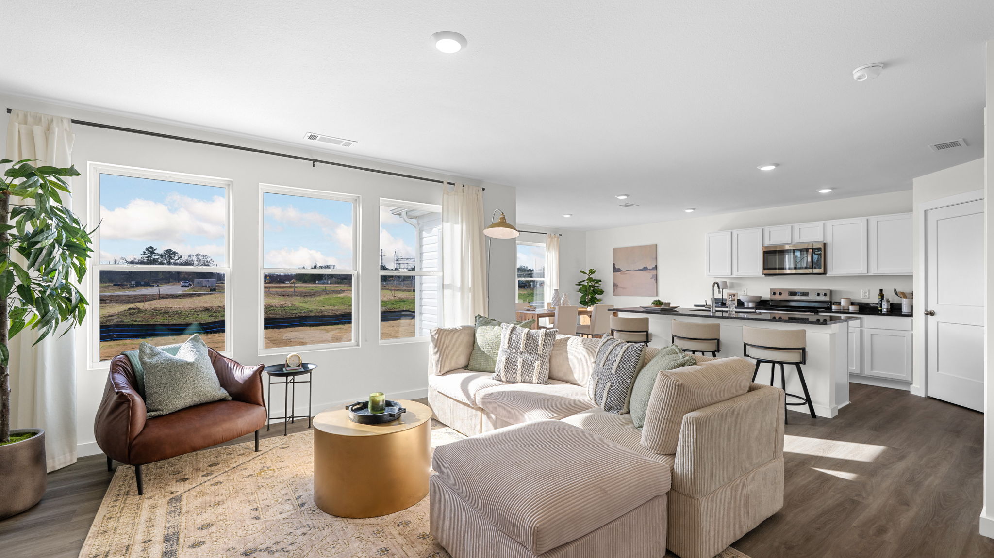 open concept living room with triple window
