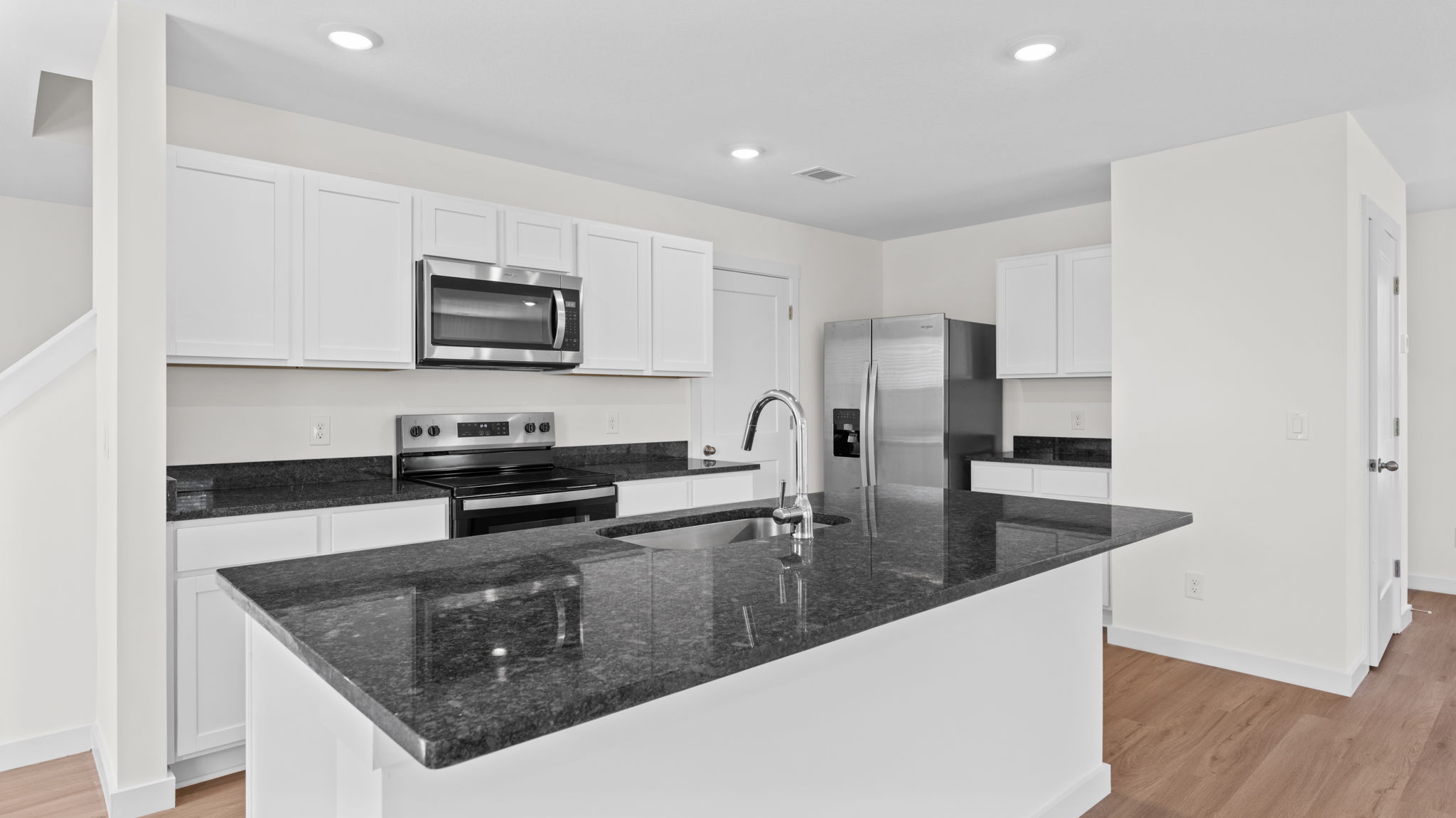 open concept kitchen with island and stainless steel appliances
