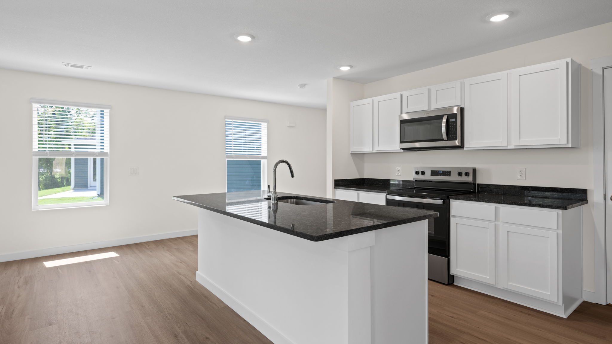 open concept kitchen with island and stainless steel appliances