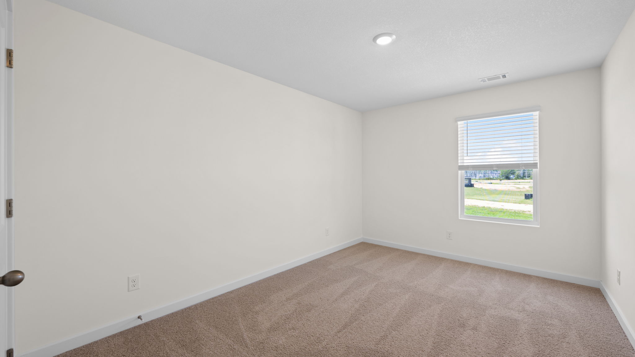 guest bedroom with single window and carpet
