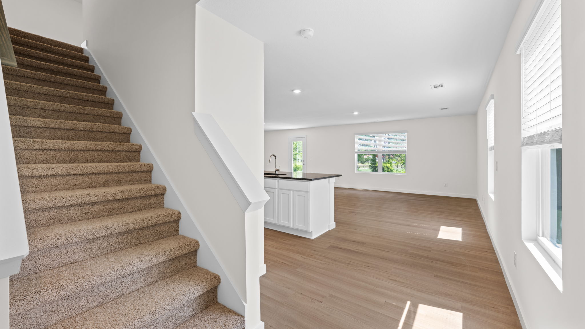 downstairs foyer and open concept kitchen