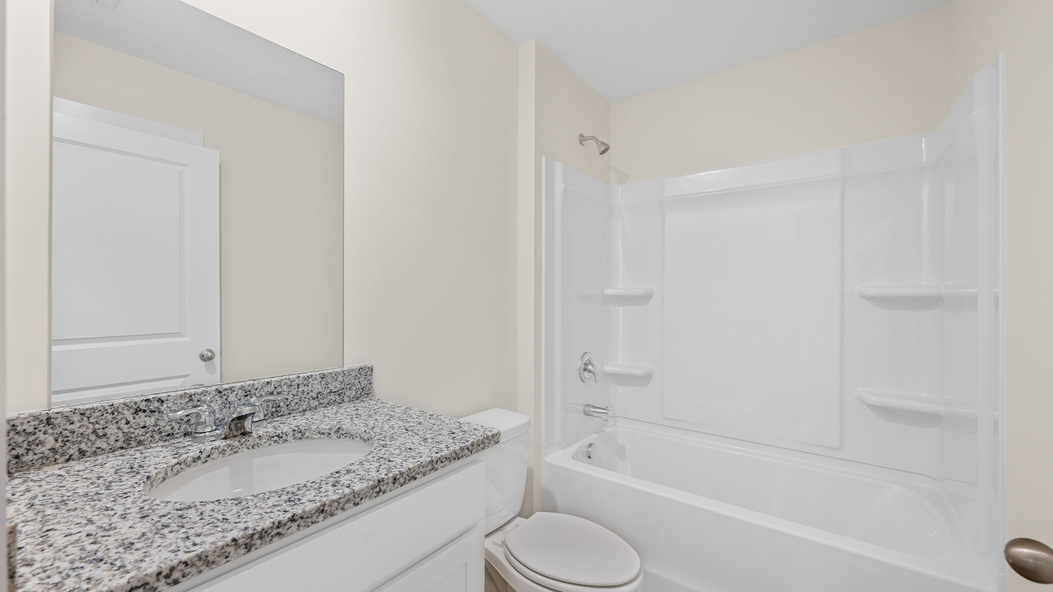 bathroom with single vanity and shower/ tub duo