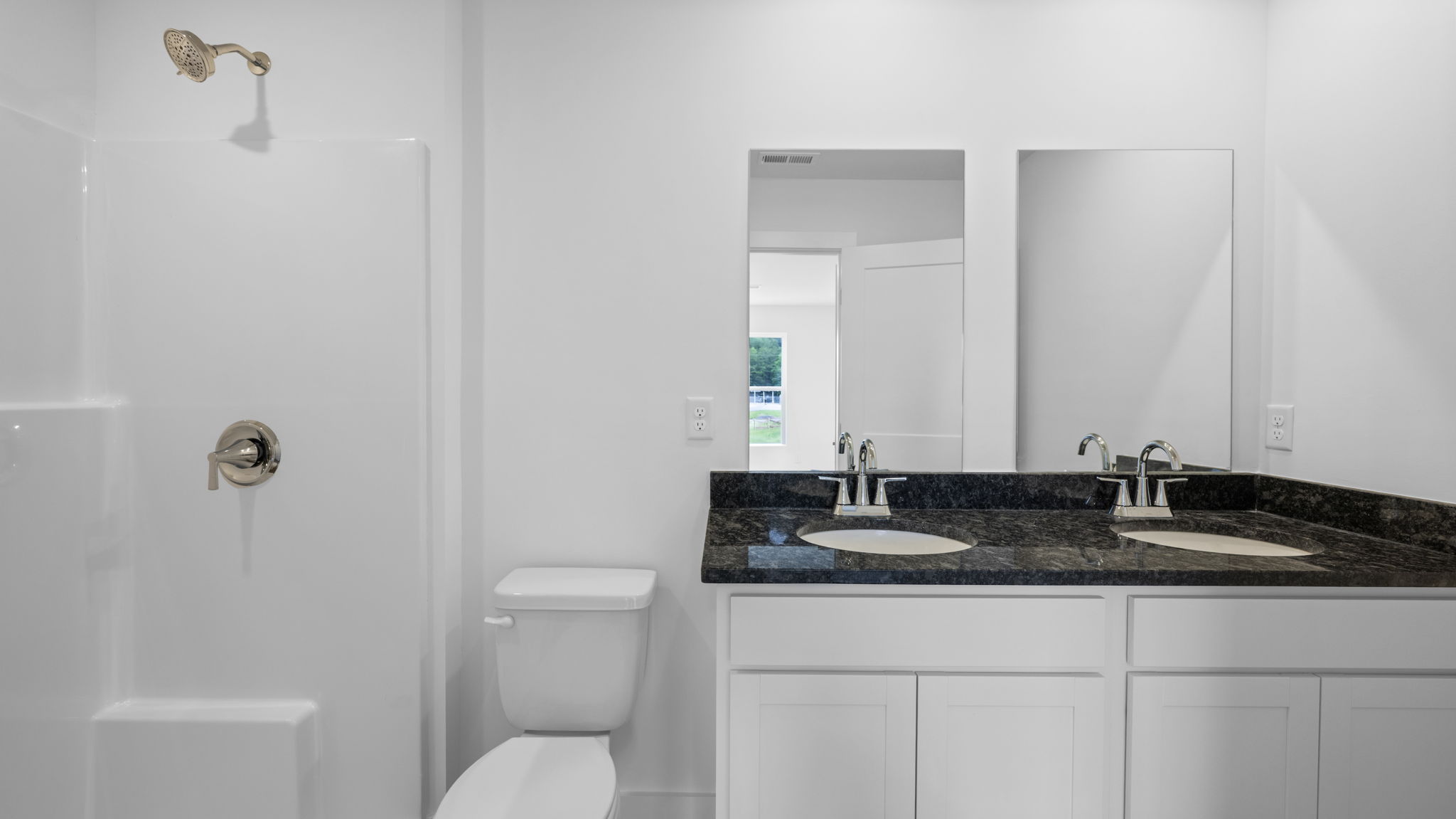 bathroom with sinks and shower