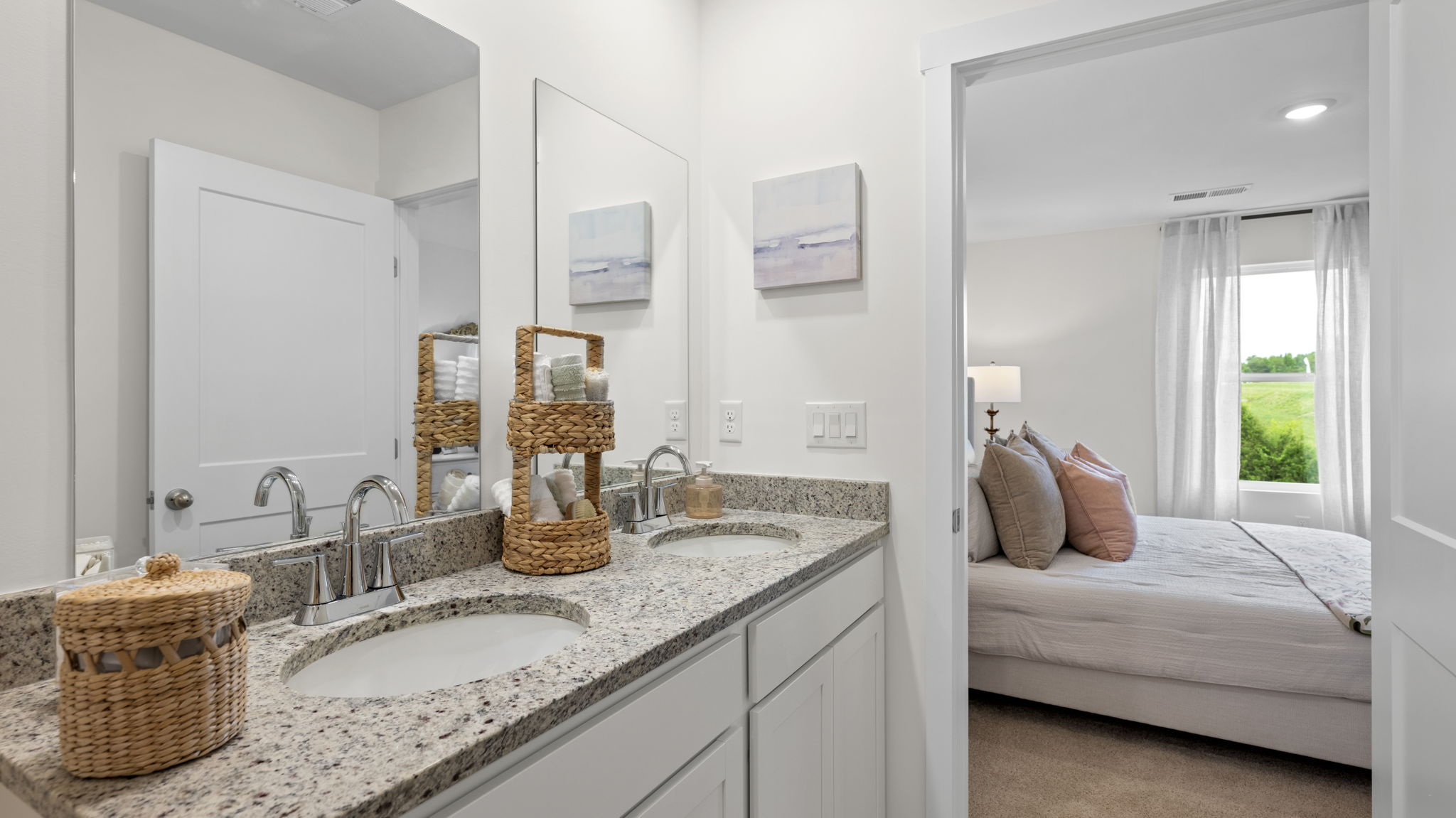 primary bathroom with double vanity and walk-in closet