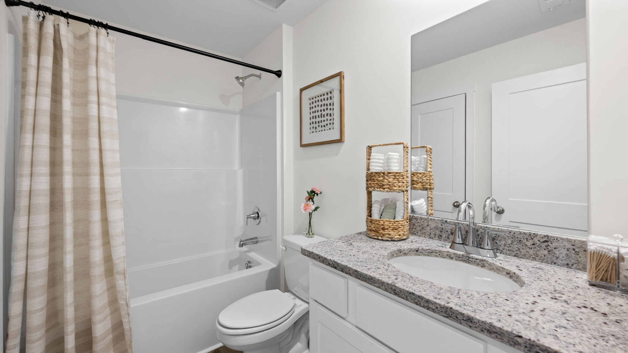 primary bathroom with double vanity and walk-in closet