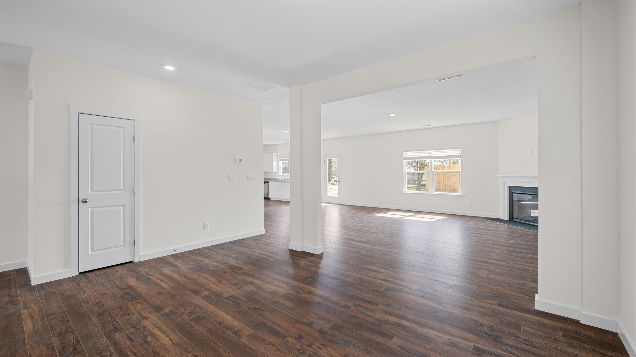 great room with solid flooring and fireplace