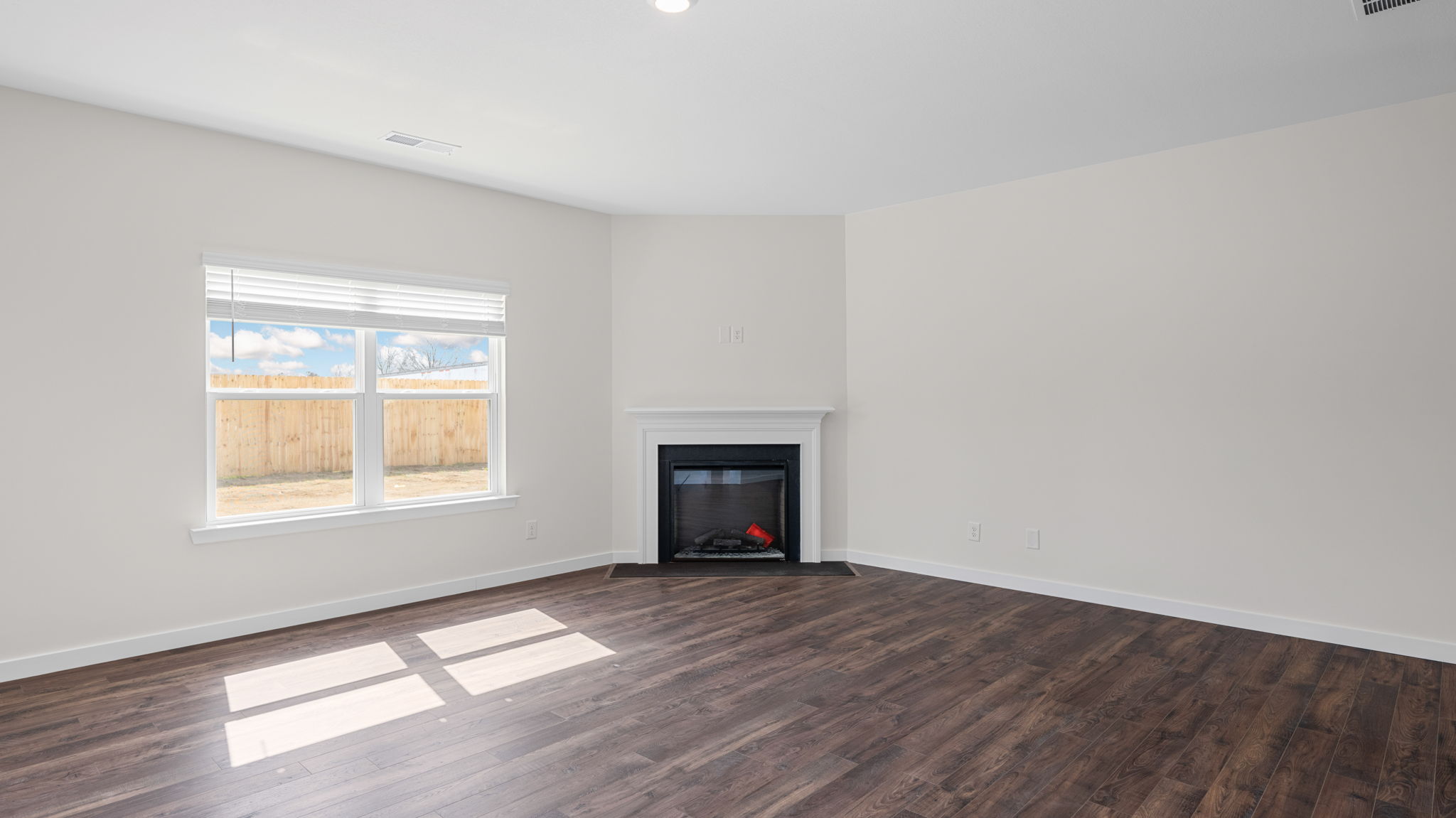 great room with solid flooring and fireplace