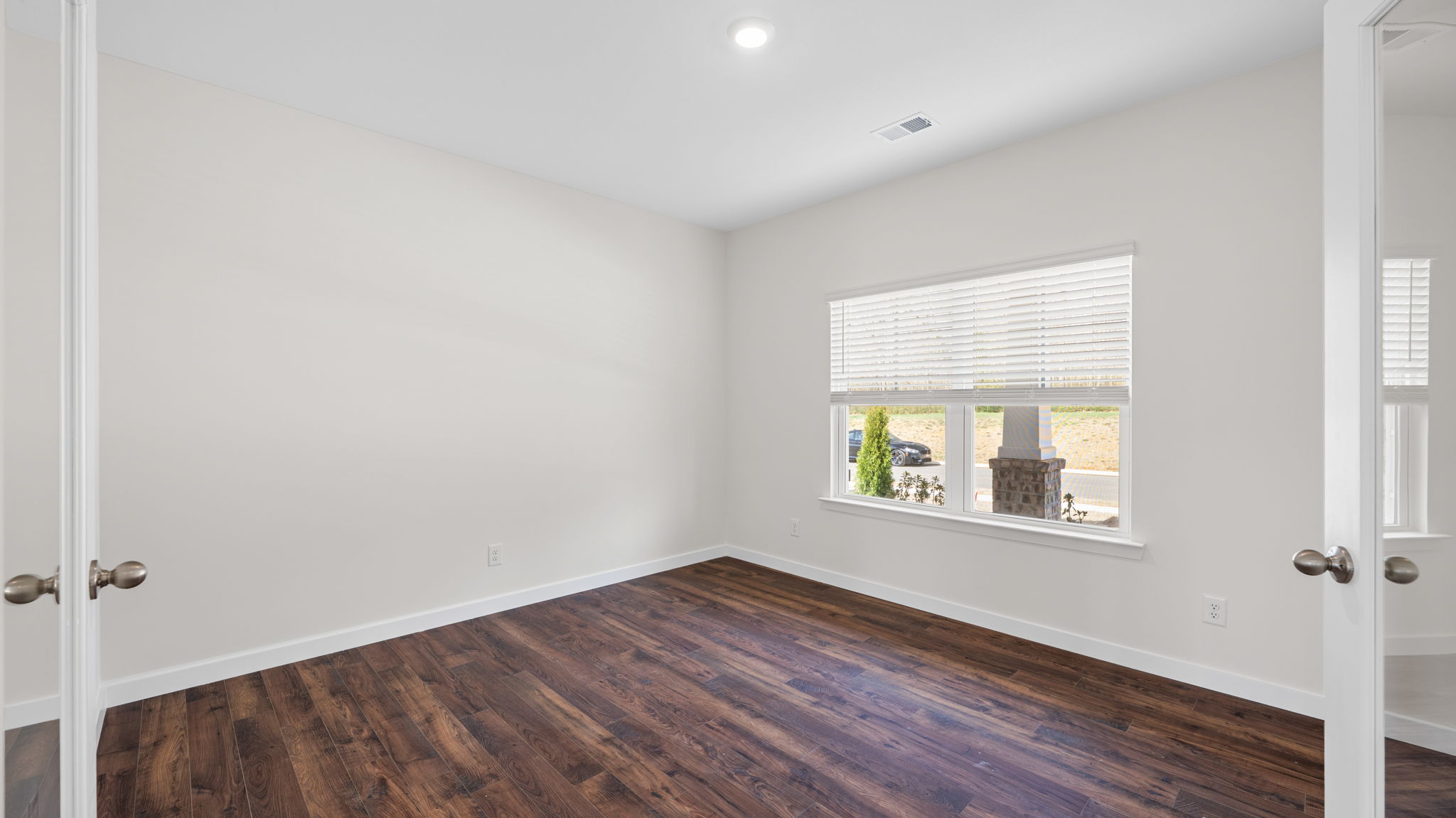study area with solid flooring and french doors