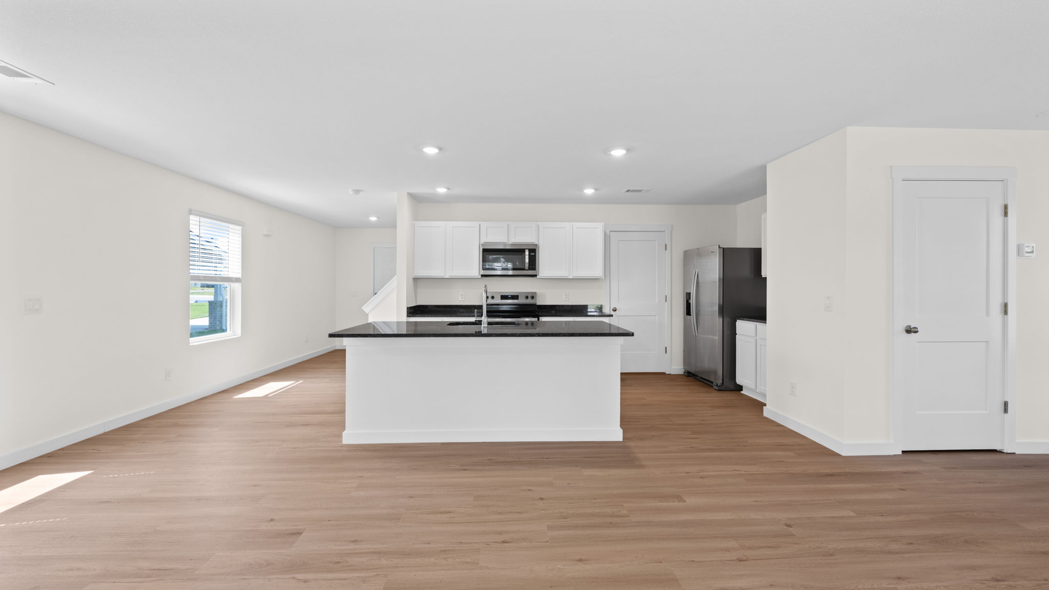 open concept kitchen with island and stainless steel appliances