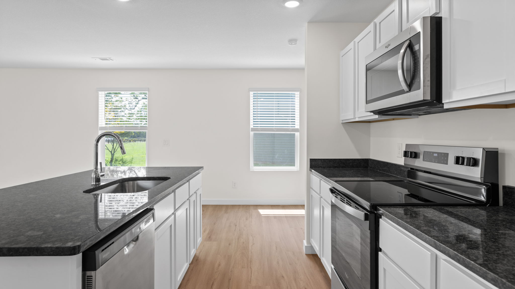 open concept kitchen with island and stainless steel appliances