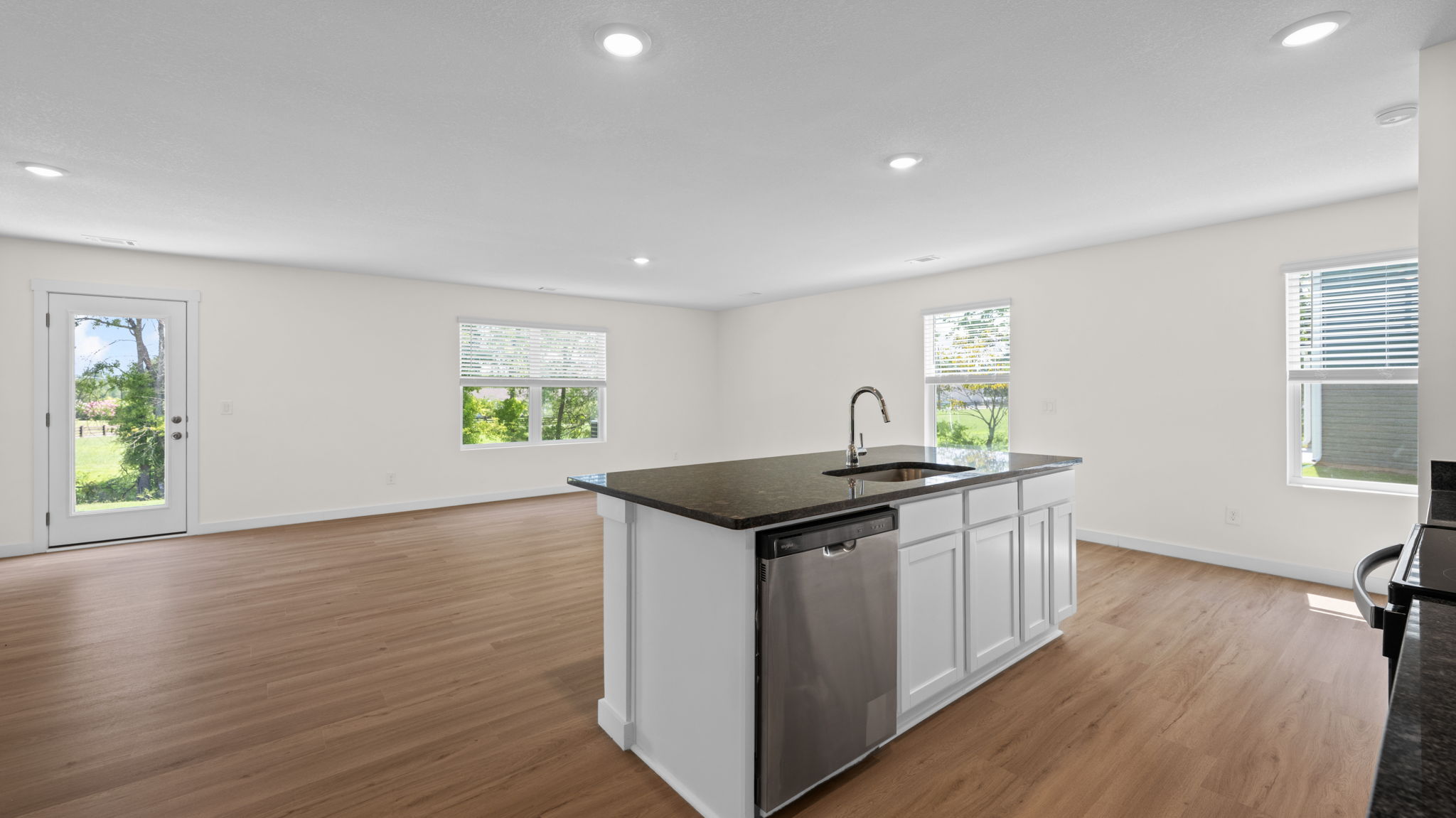 open concept kitchen with island and stainless steel appliances