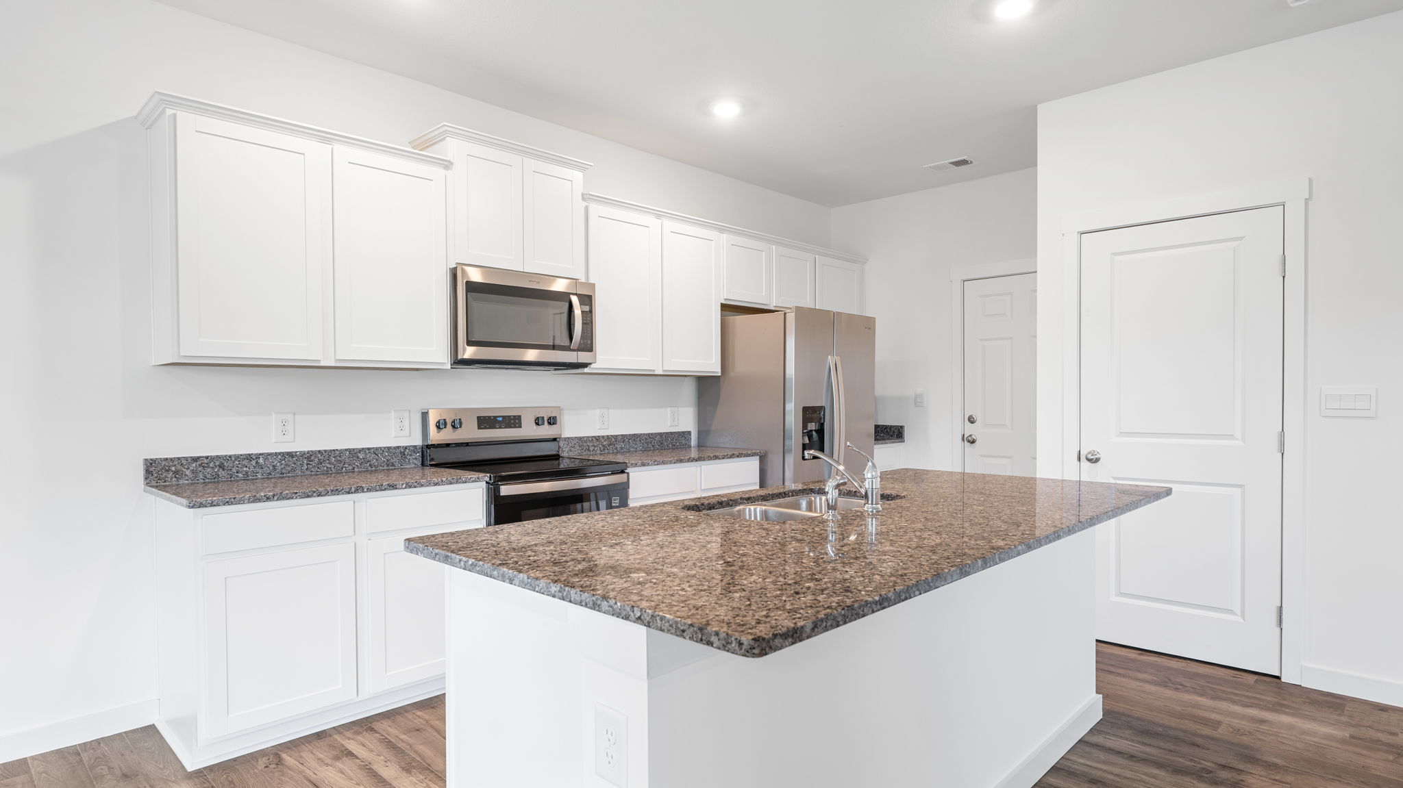 Kitchen with quartz countertop and stainless steel appliances