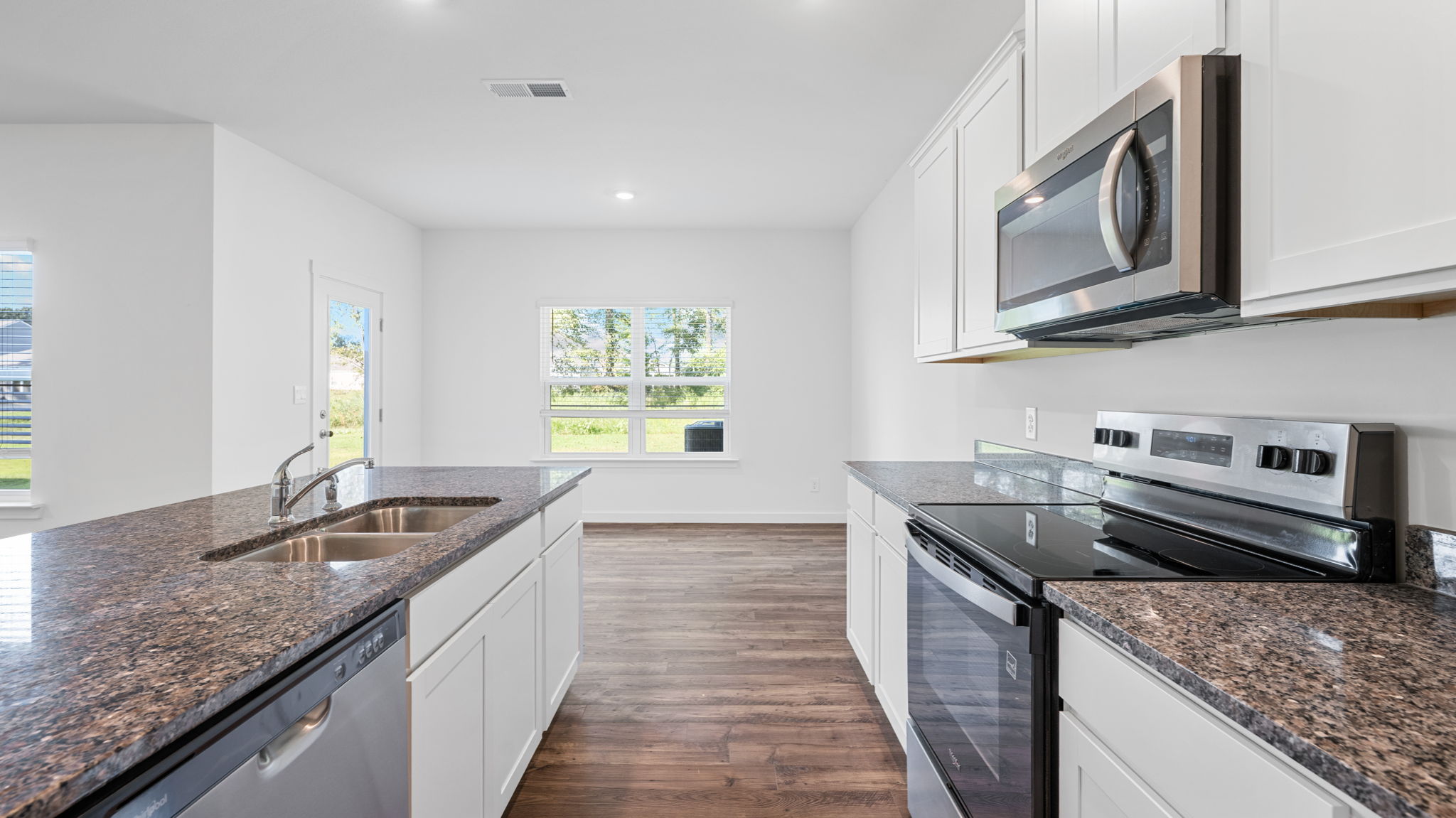 Kitchen with quartz countertop and stainless steel appliances