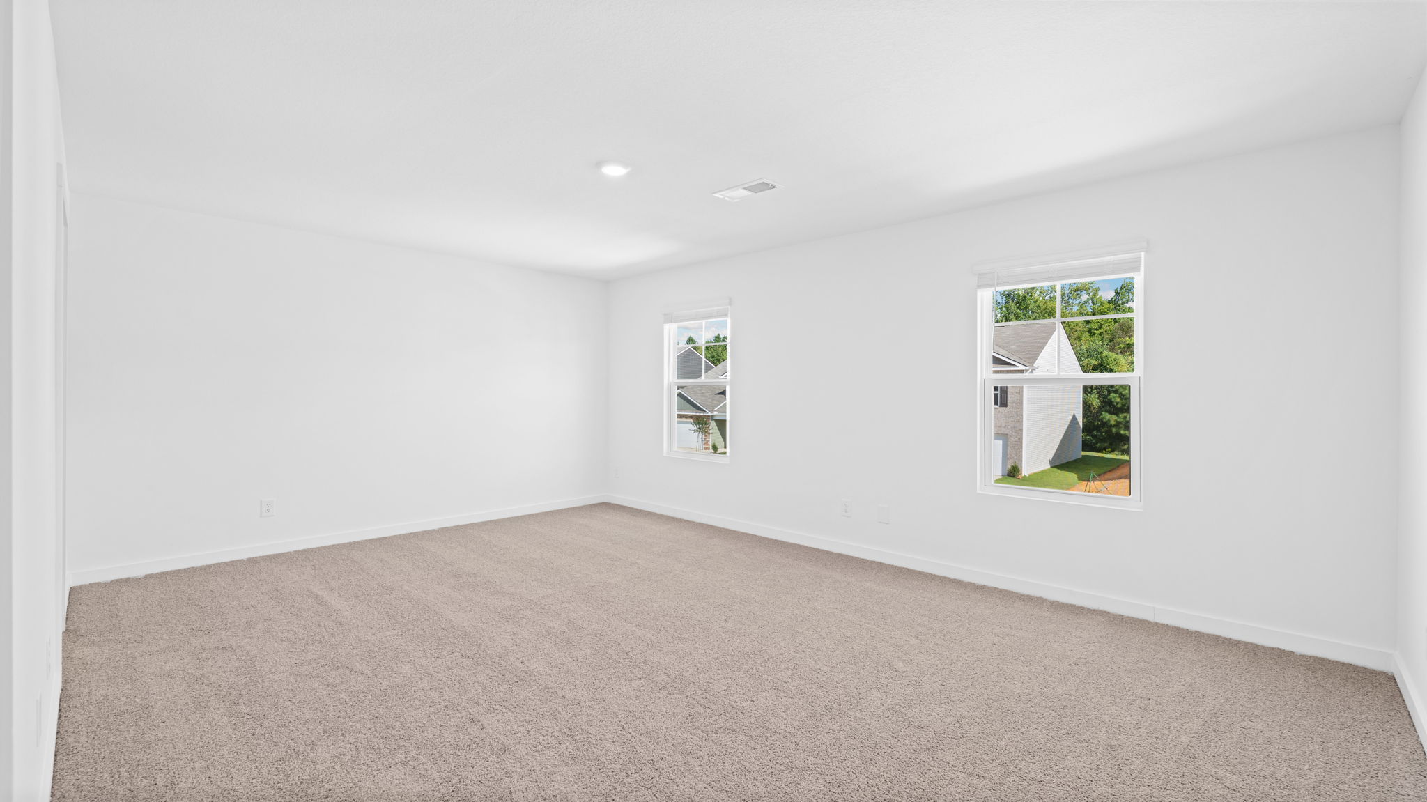 bedroom with double window and walk-in closet