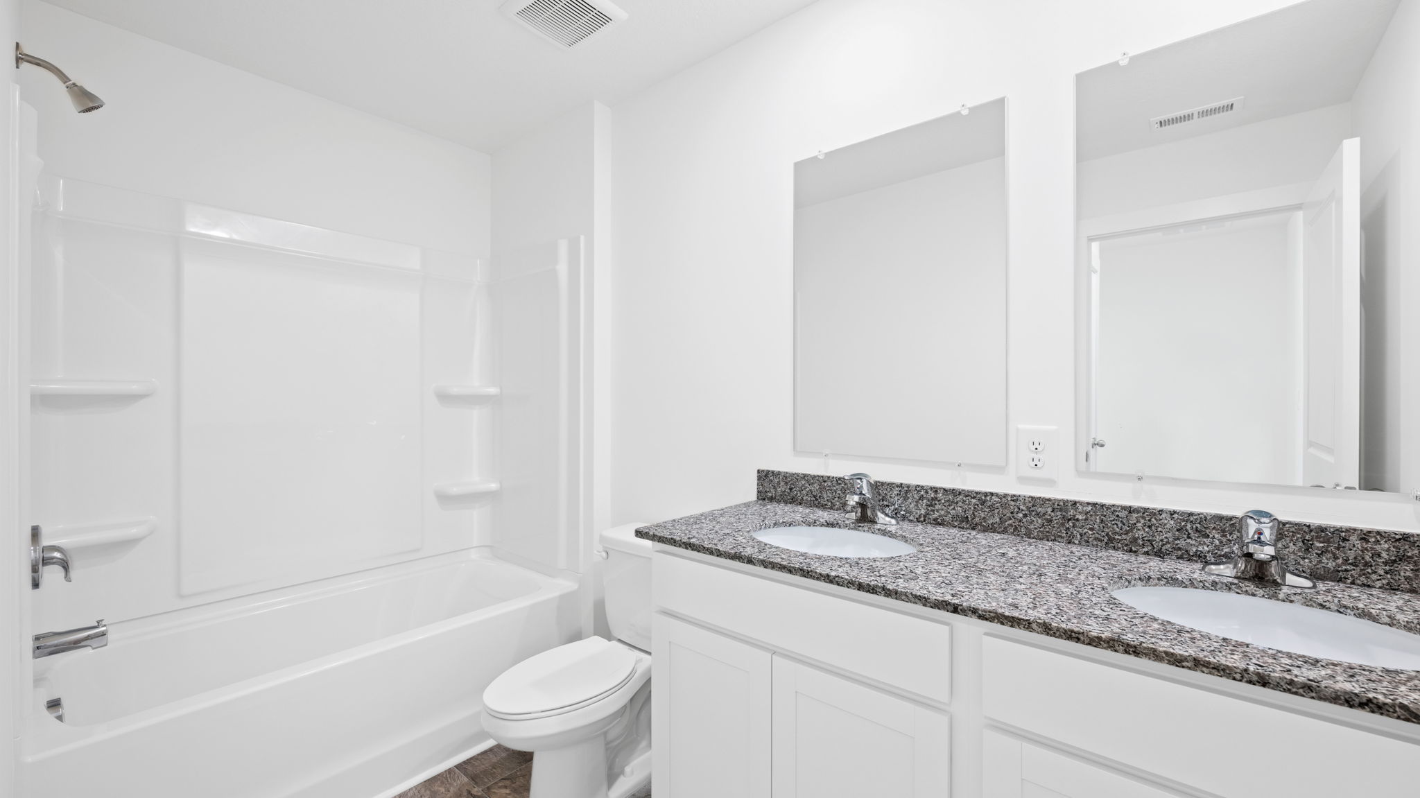 bathroom with double vanity and shower/ tub duo