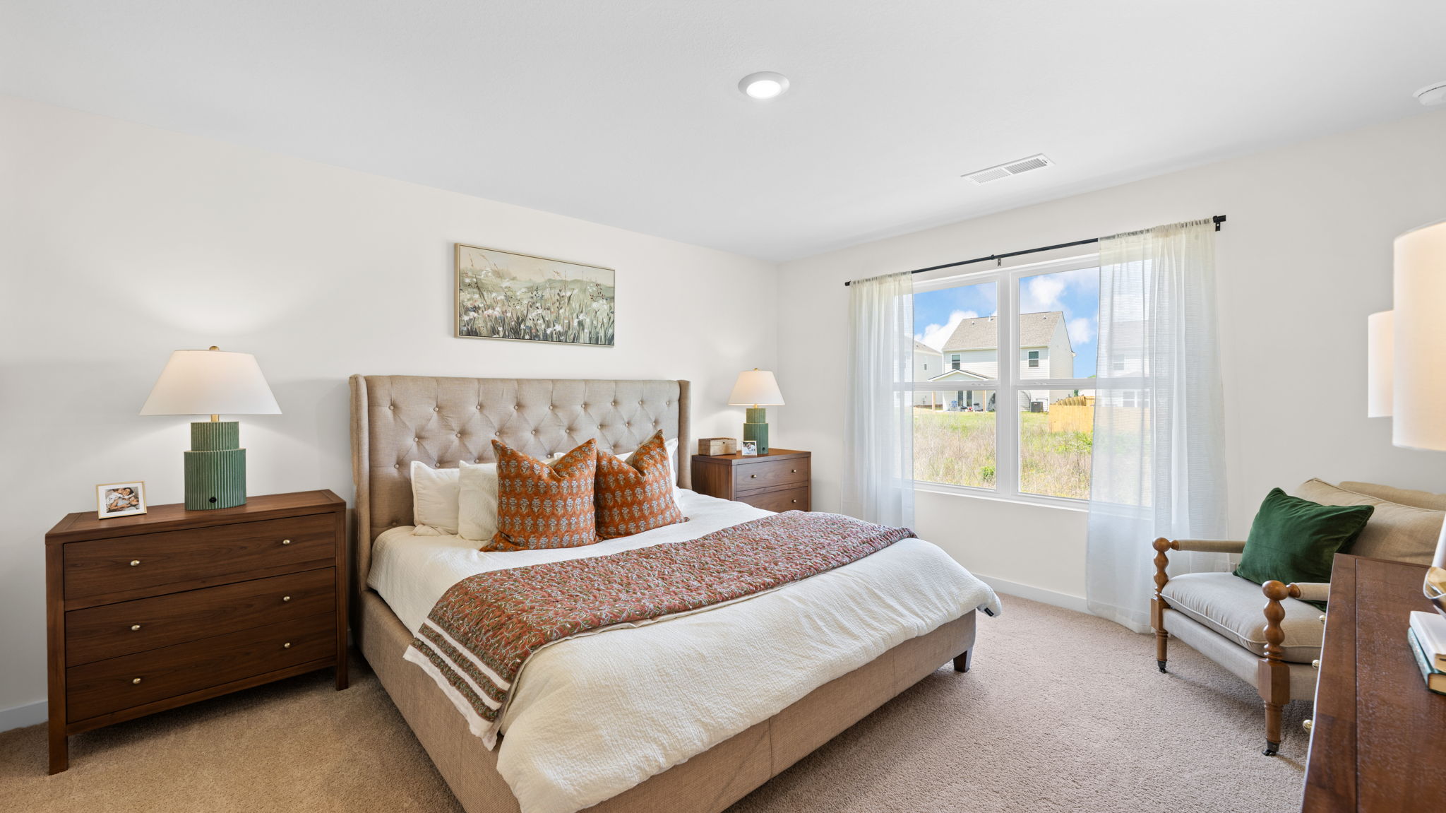 primary bedroom with double window and en suite