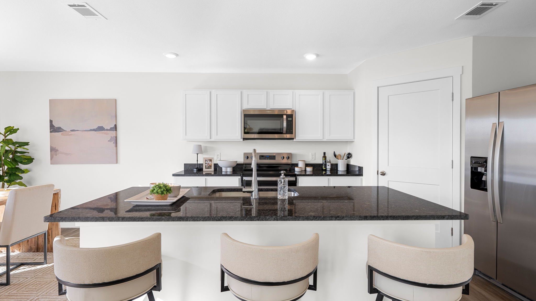 open concept kitchen with large island and walk-in pantry