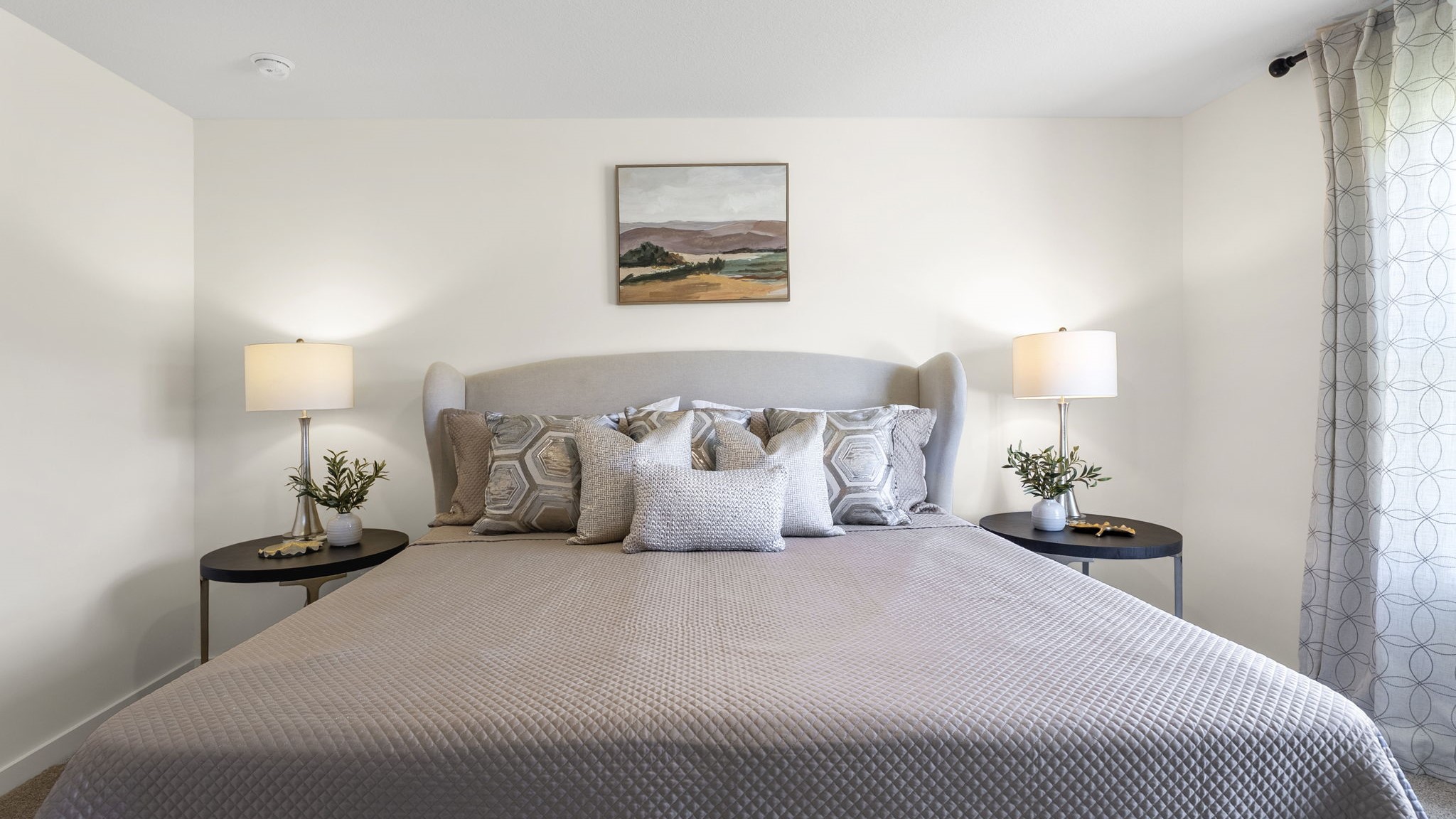 Primary bedroom with double window and carpet