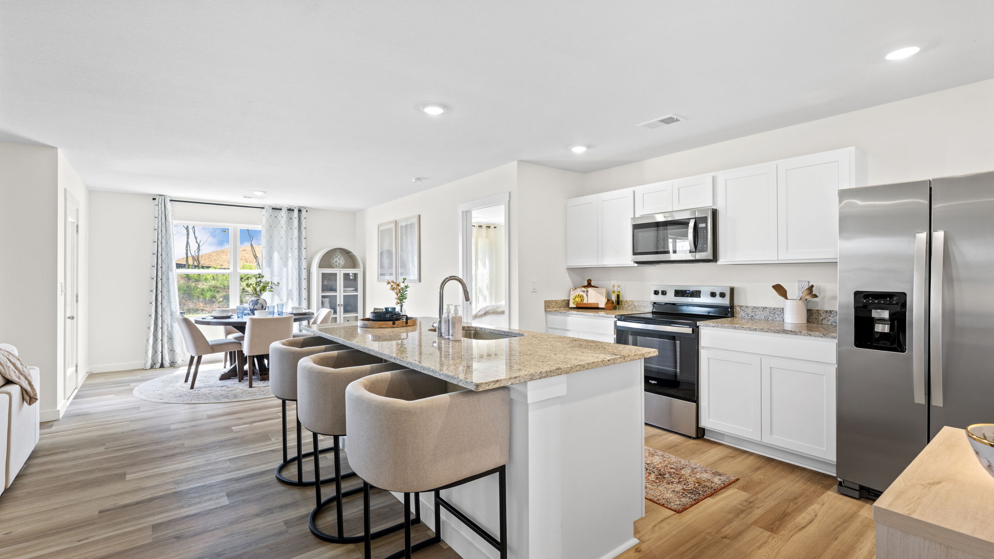 open concept kitchen with large island and stainless steel appliances