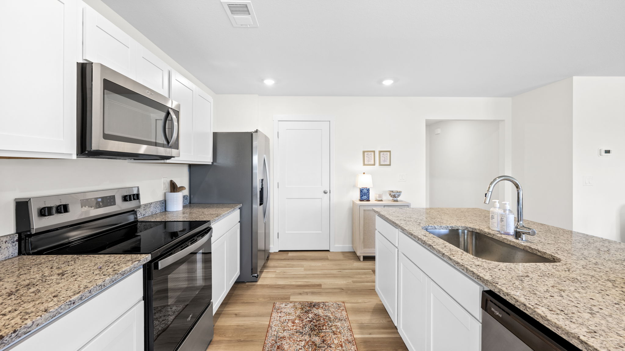 open concept kitchen with large island and stainless steel appliances