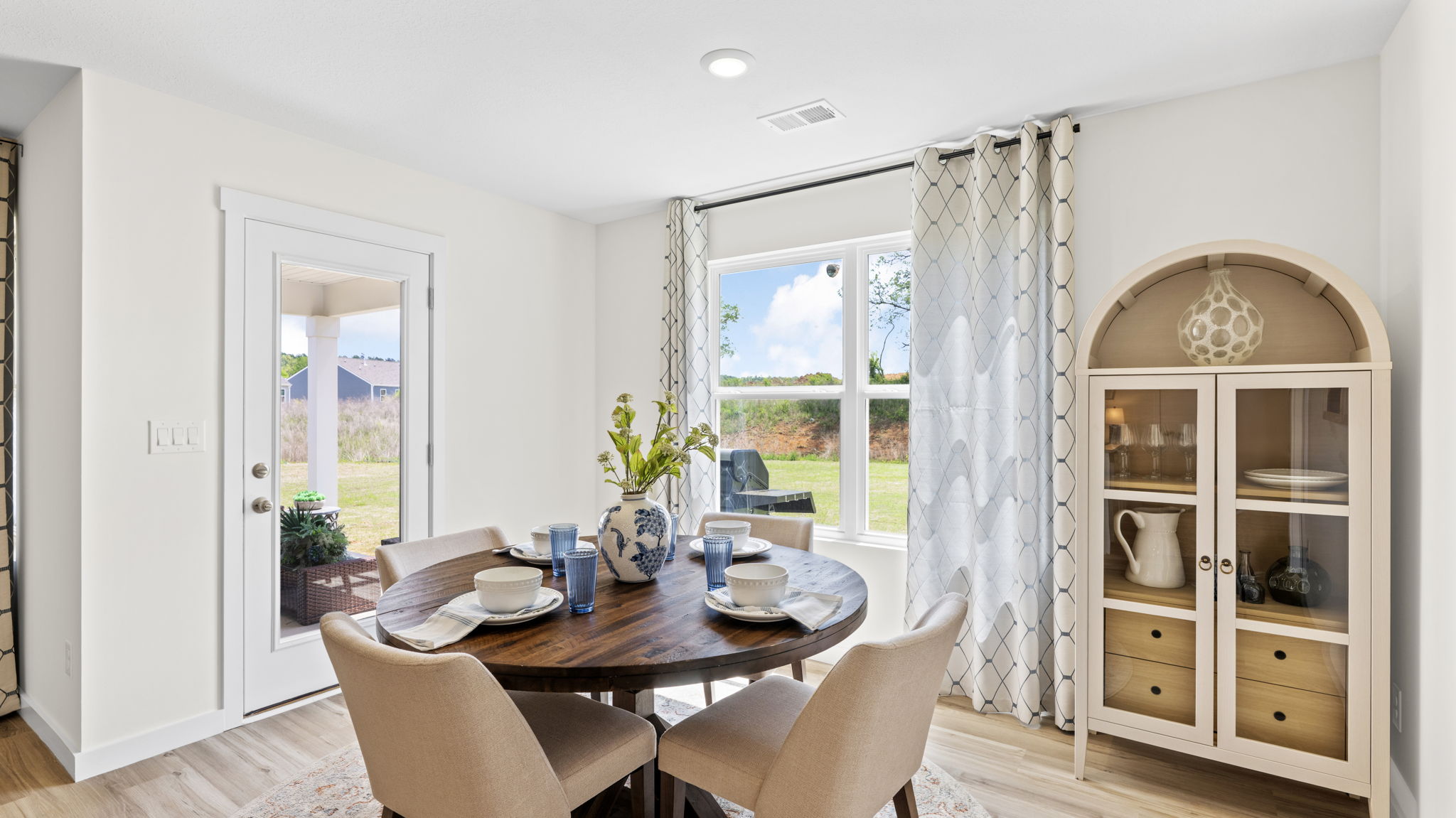 informal dining with double window and back patio door