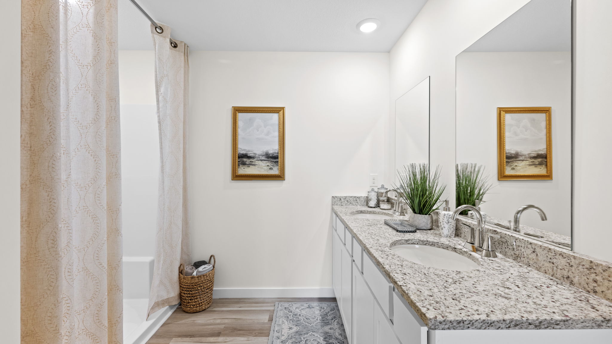 primary bathroom with double vanity and walk-in shower