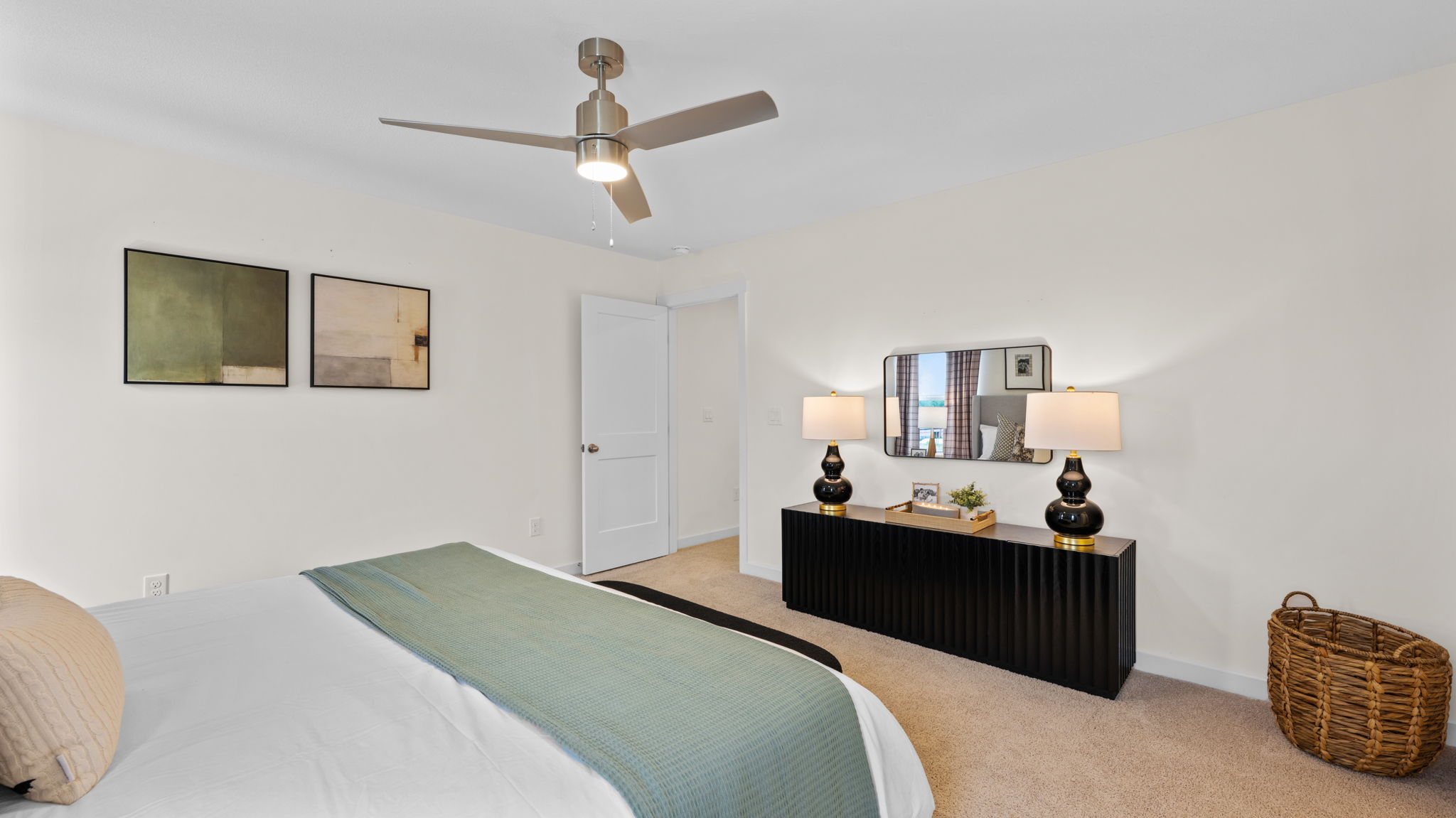 primary bedroom with double windows and carpet