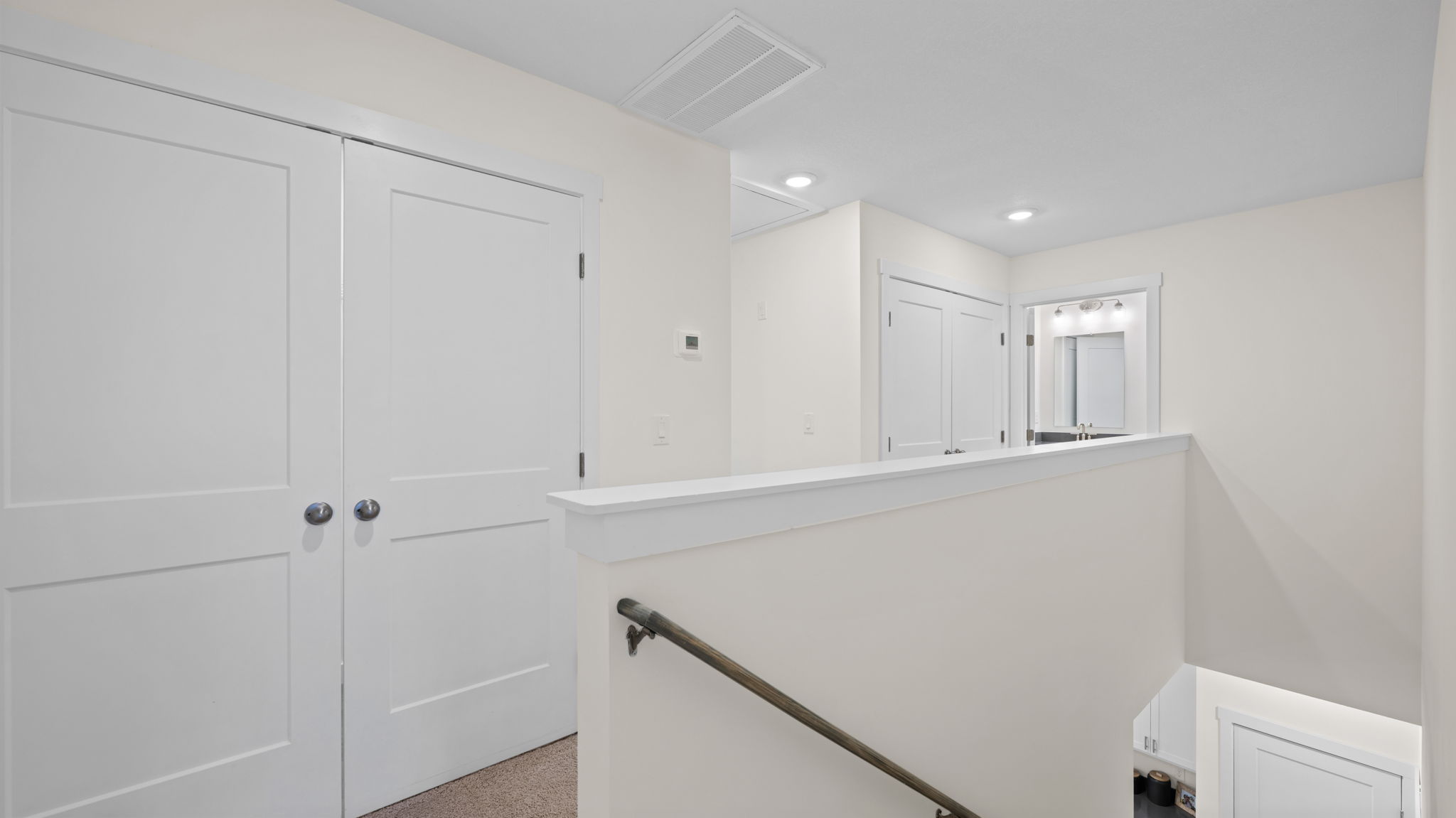 upstairs hallway with carpet