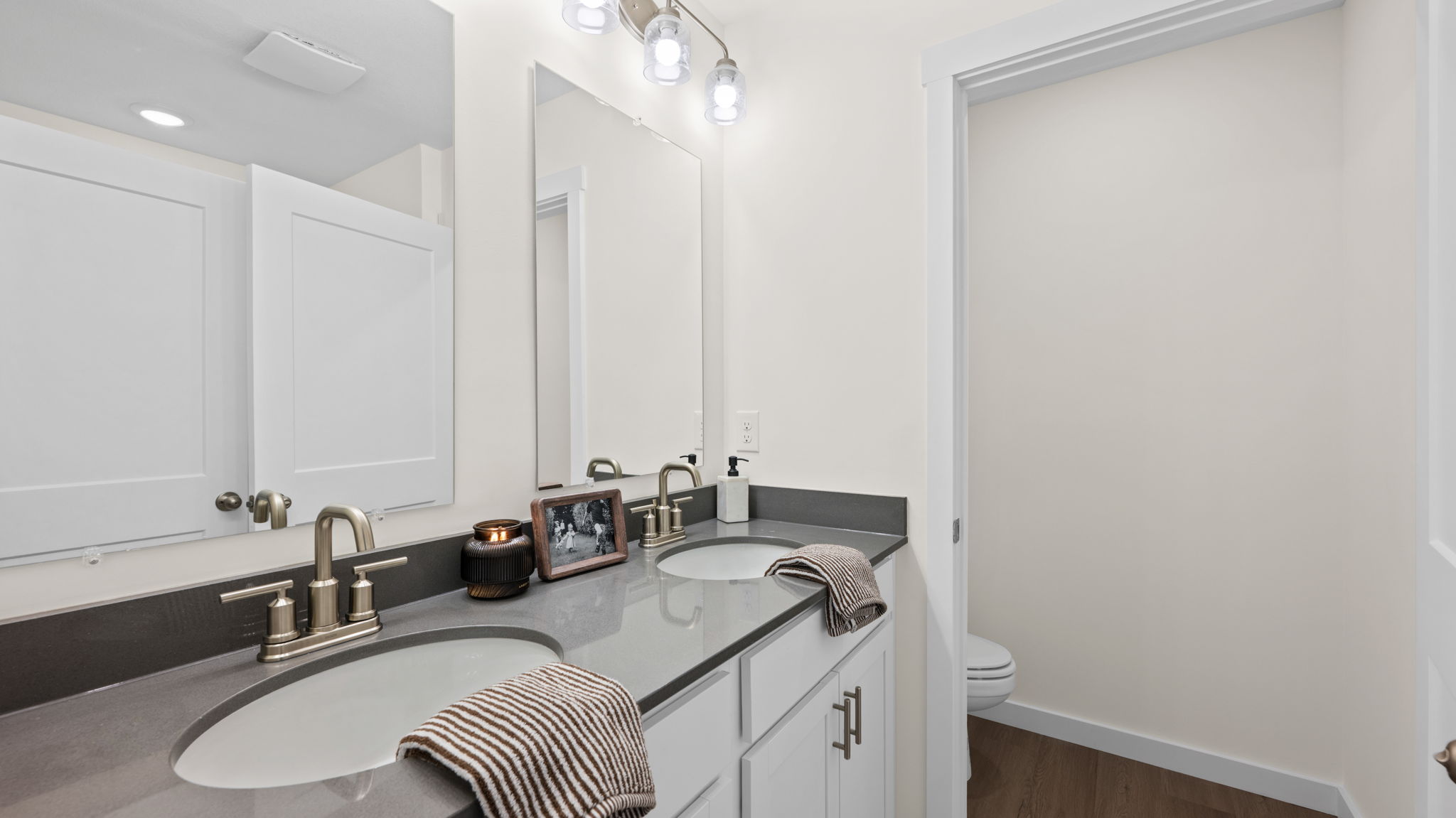 primary bedroom en suite bathroom with double sink bowls