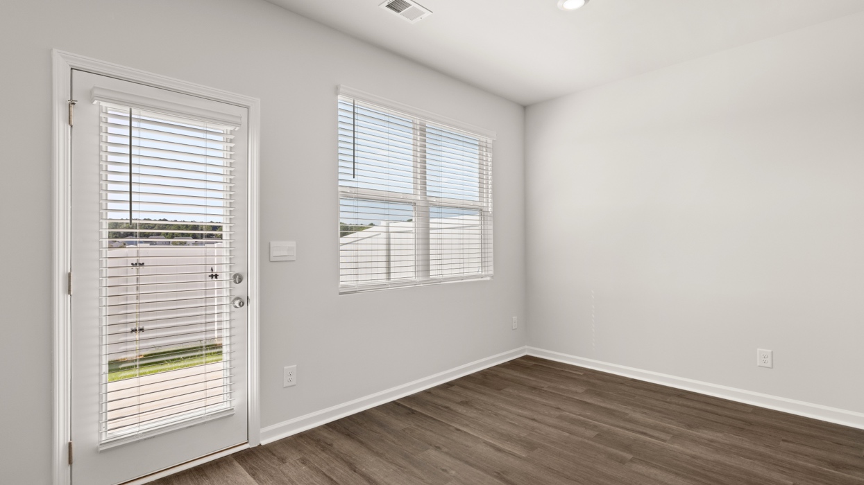 dining area with back patio door and double window