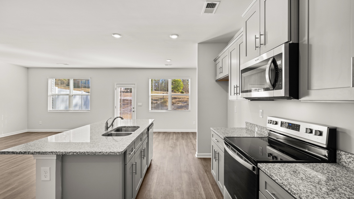 open concept kitchen with large island and stainless steel appliances