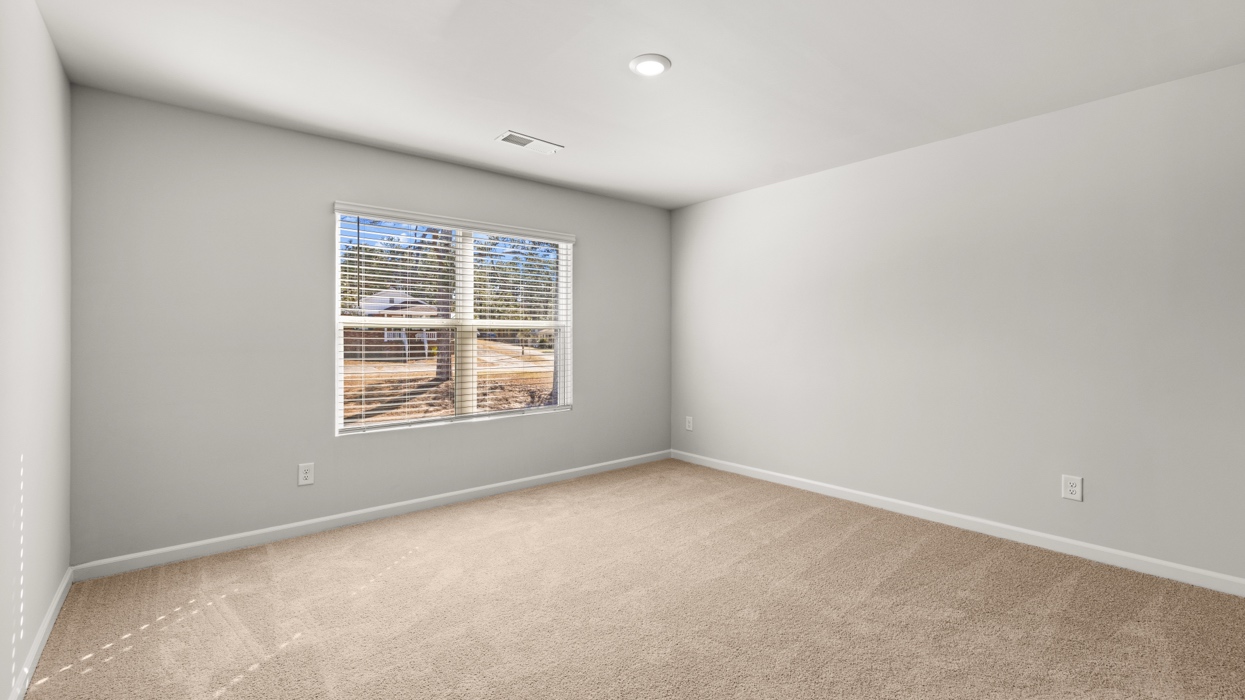 primary bedroom with double window and en suite