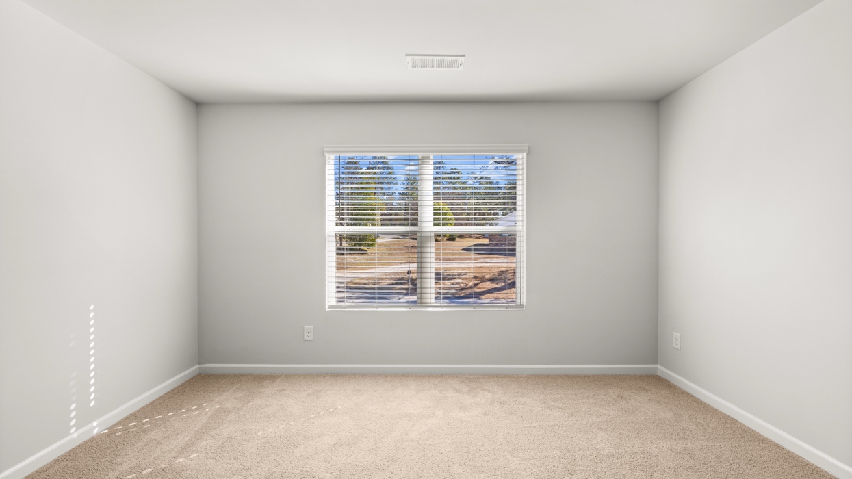 primary bedroom with double window and en suite