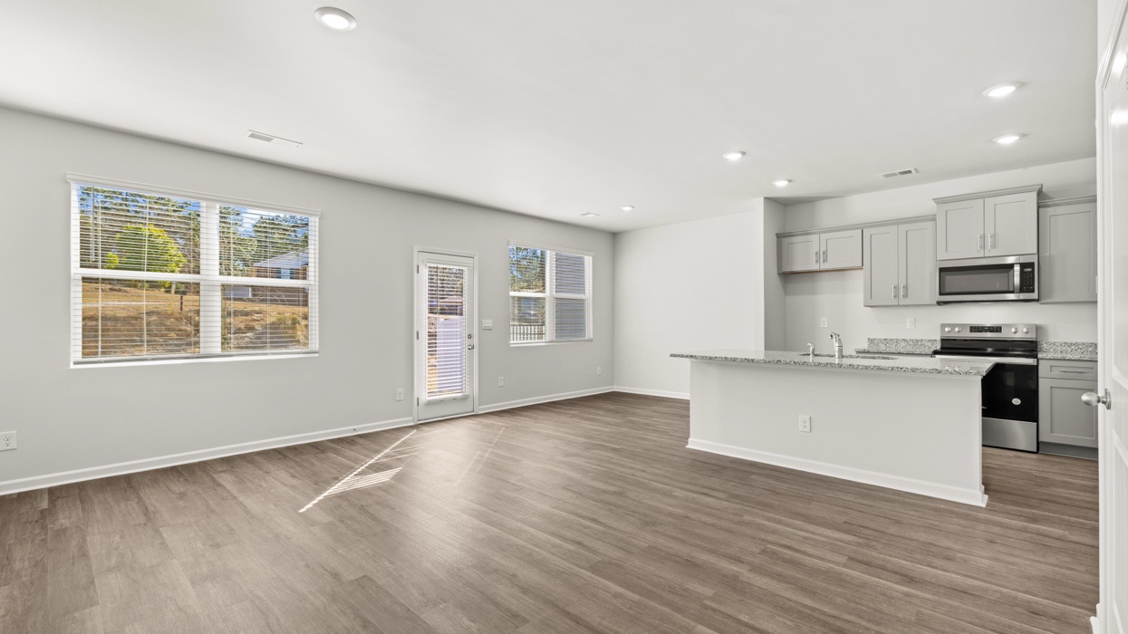 open concept kitchen with large island and stainless steel appliances