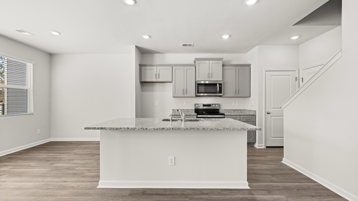 open concept kitchen with large island and stainless steel appliances