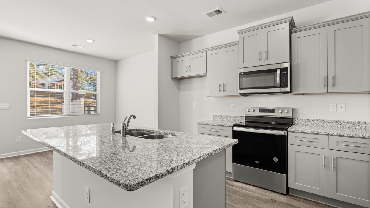 open concept kitchen with large island and stainless steel appliances