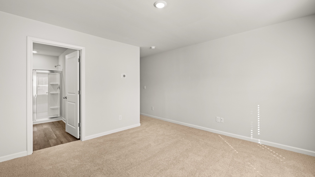primary bedroom with double window and en suite