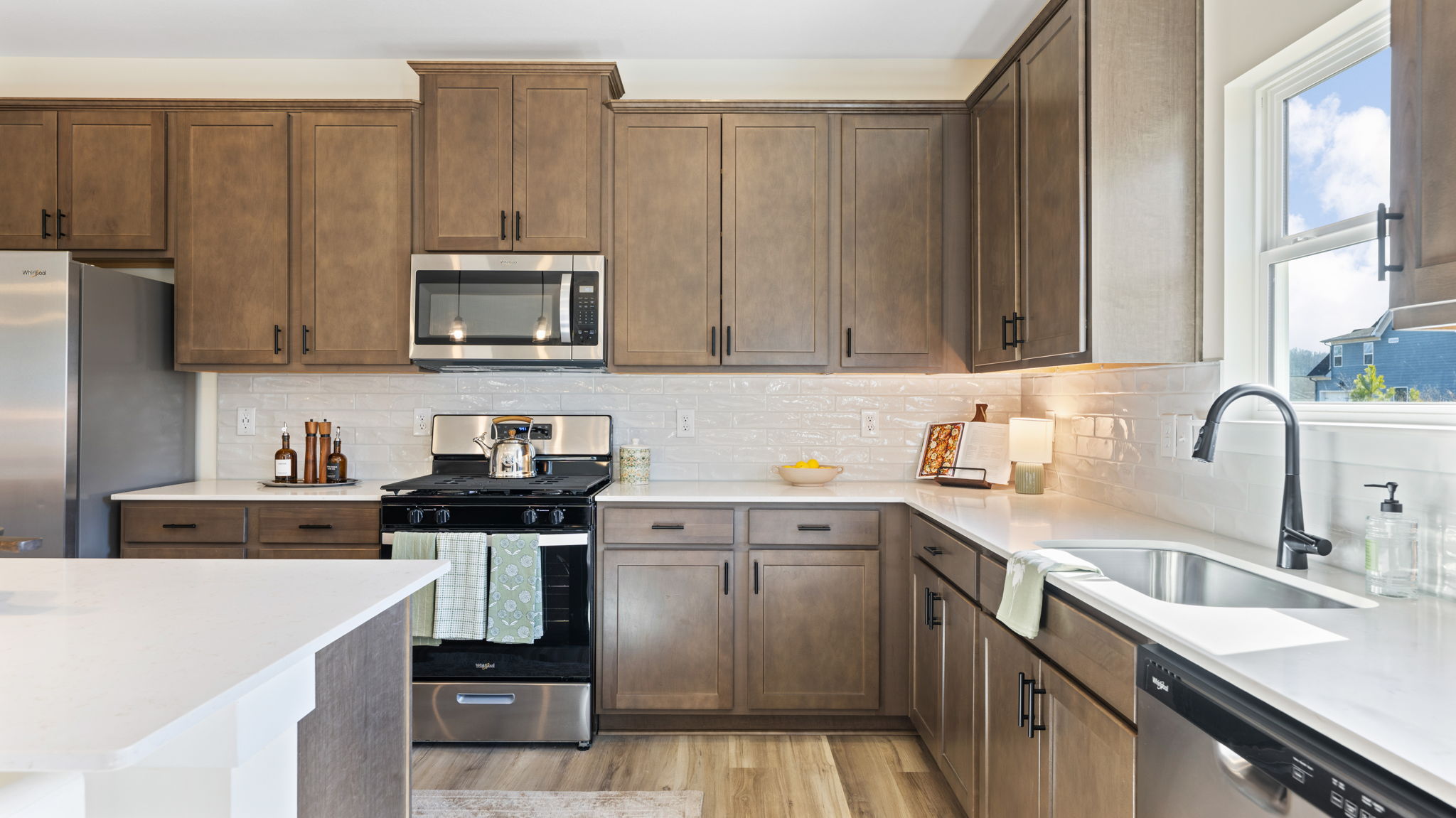 open concept kitchen with large island and stainless steel appliances