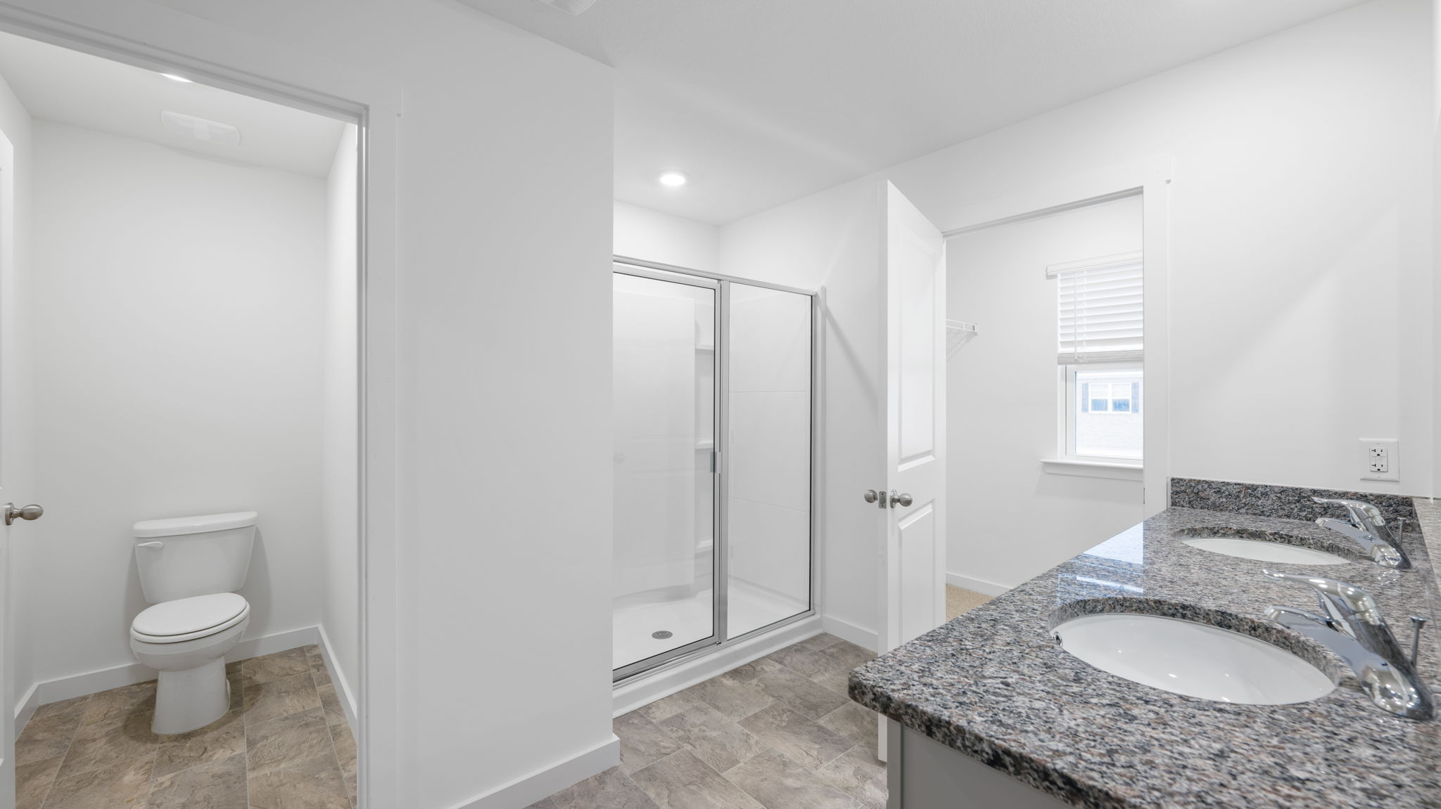 primary bathroom double vanity and walk-in shower